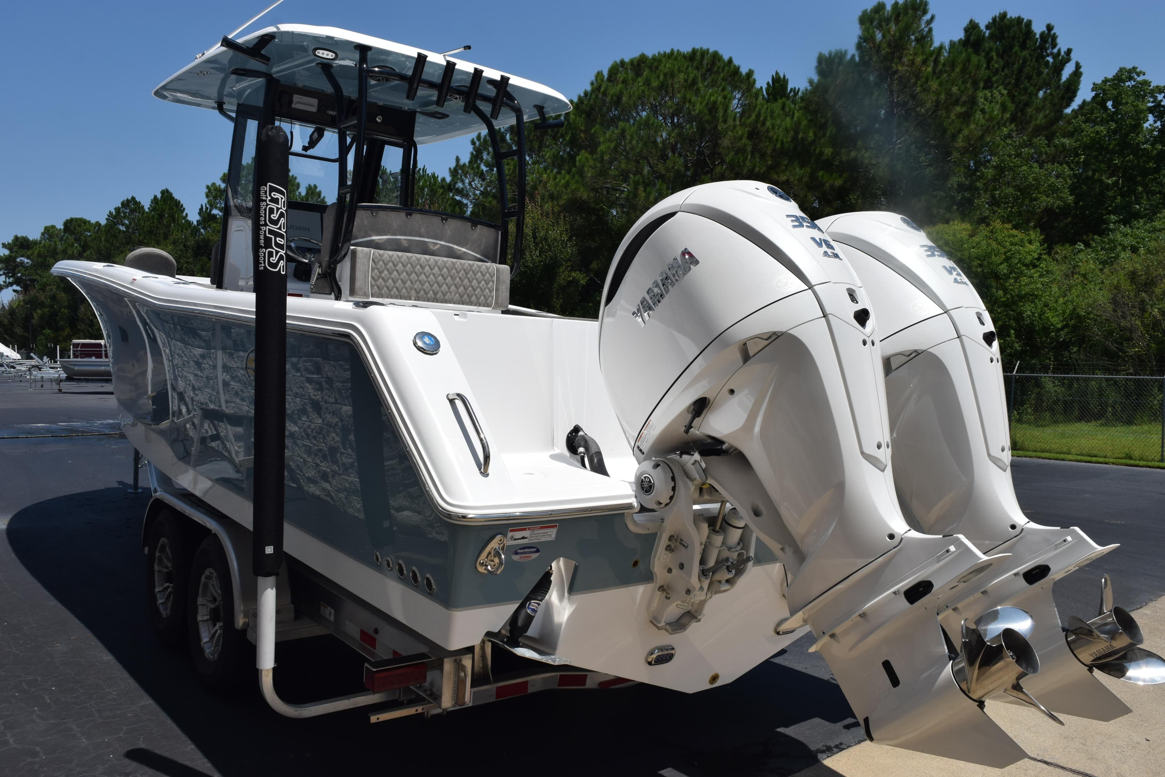 2026 Sea Hunt Gamefish 30 boat with dual Yamaha outboard engines, parked outdoors.