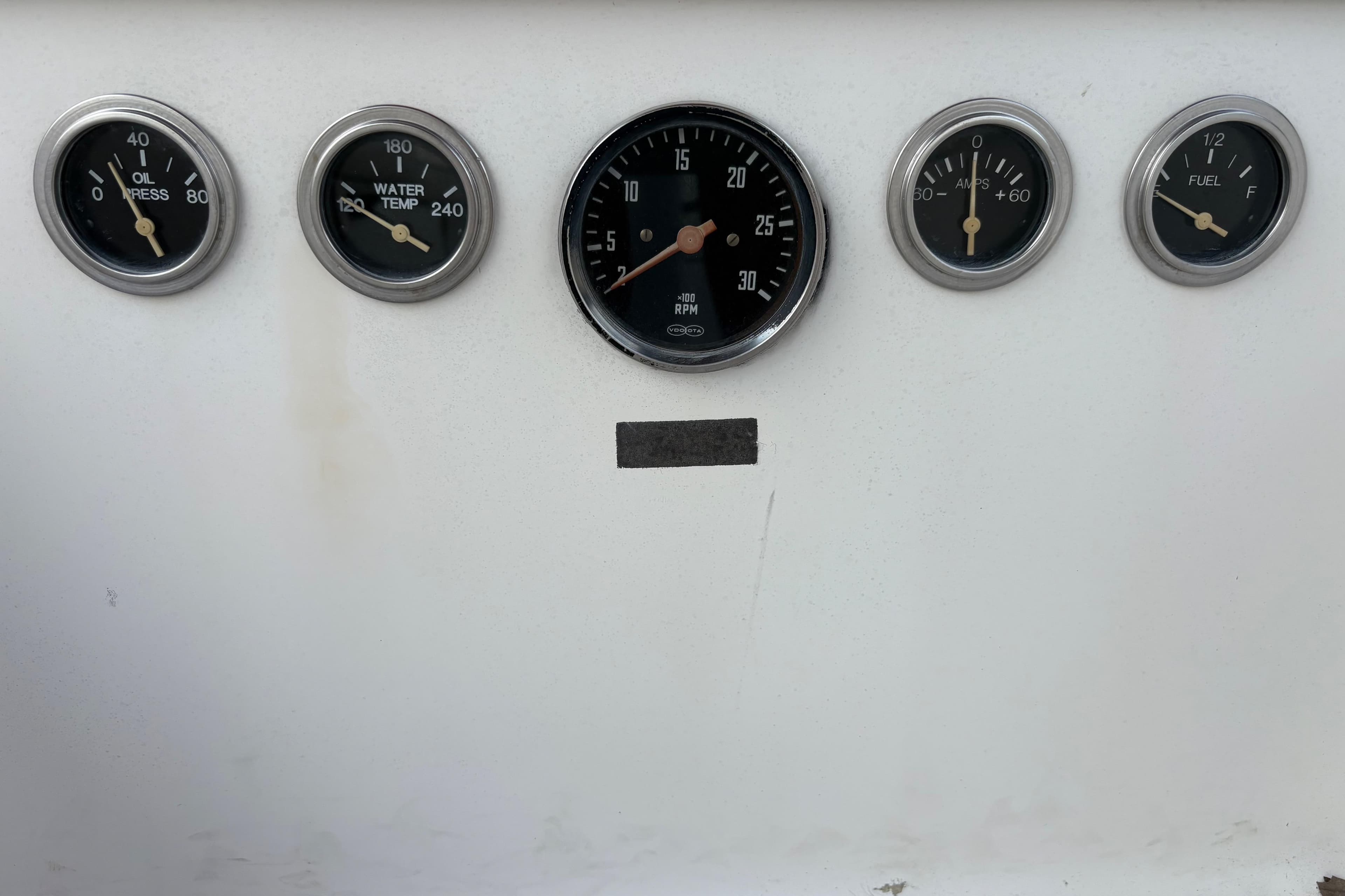 Instrument panel of a 1981 Sabre 31 boat with gauges for oil, water, RPM, amps, and fuel.
