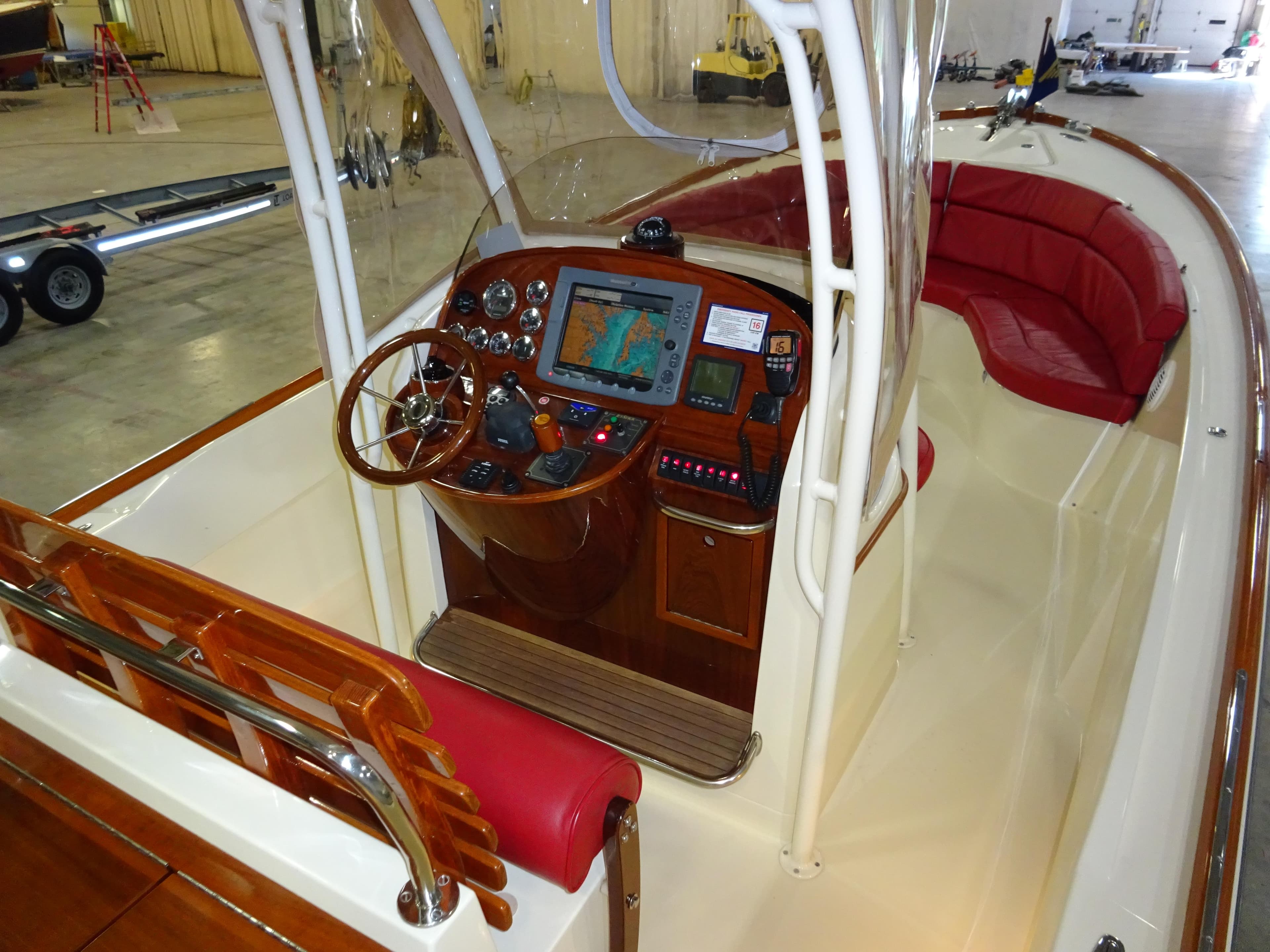 2007 Hinckley T29C boat interior with navigation system and red seating.
