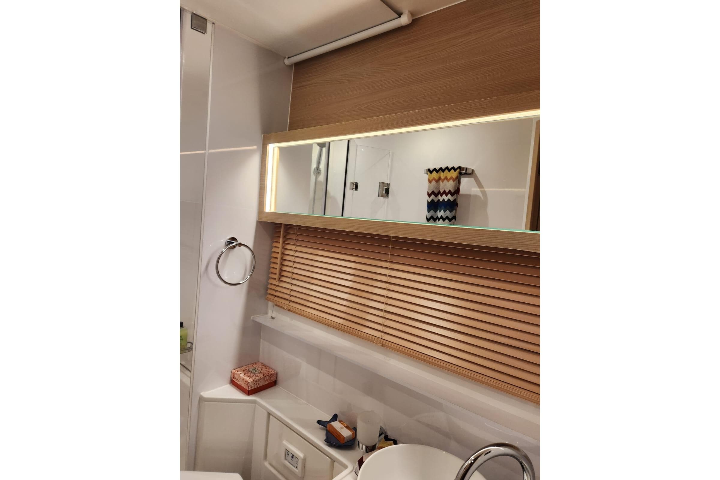 Luxurious bathroom interior of 2024 Aquila 54 Yacht with modern fixtures and wooden accents.