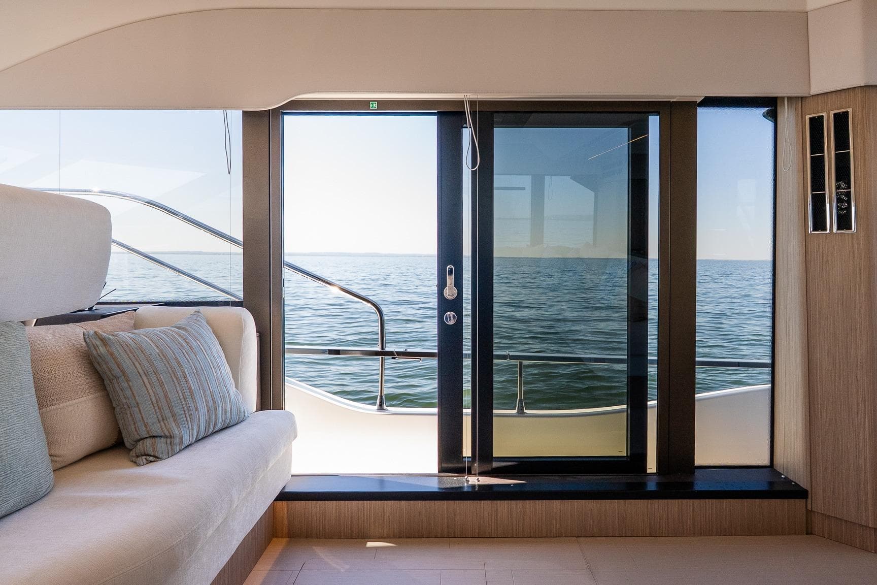 Luxurious Prestige F5.7 yacht interior with ocean view through glass doors, 2026 model.
