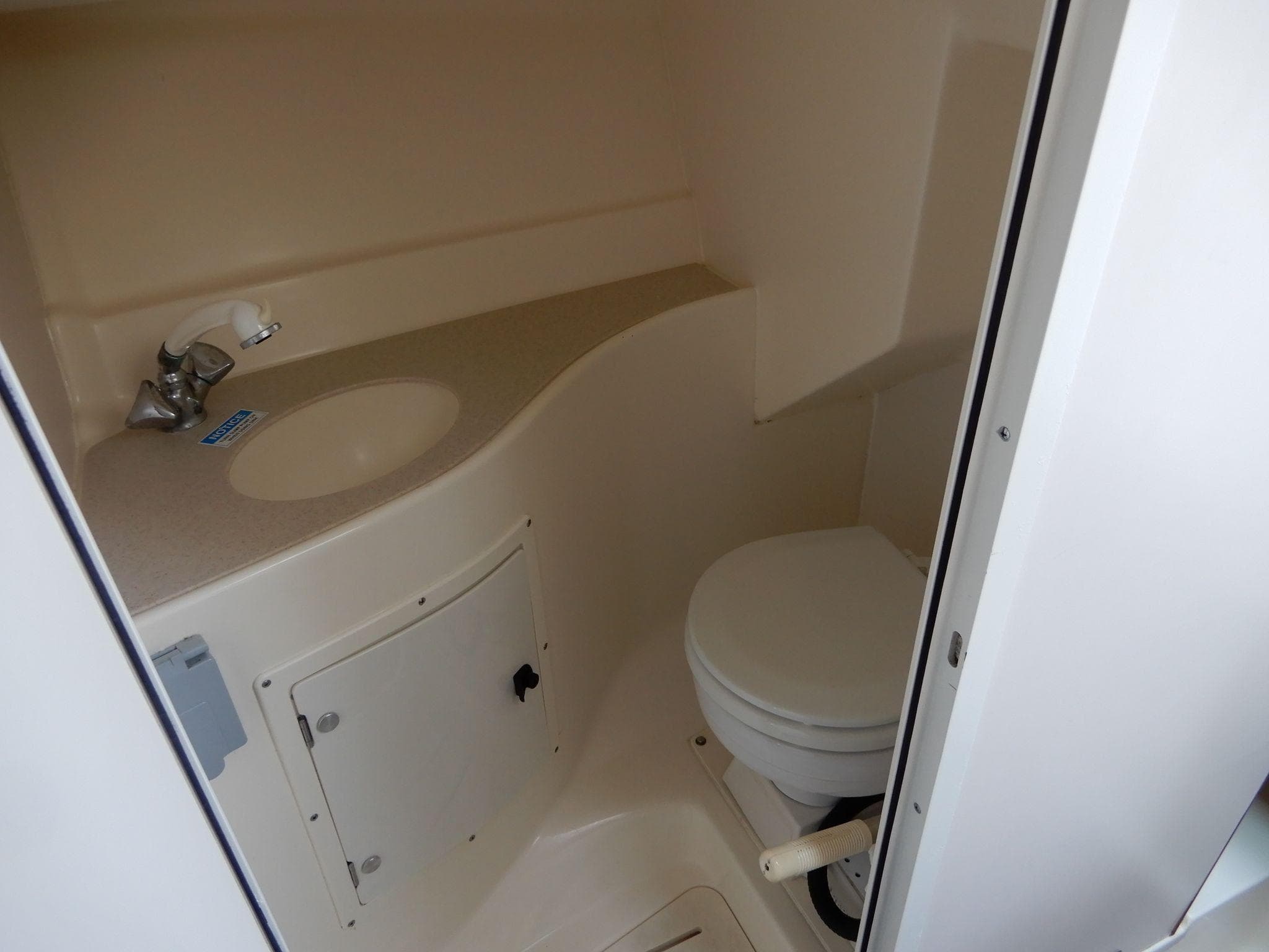 1999 Pursuit 2860 Denali boat bathroom with sink and toilet.