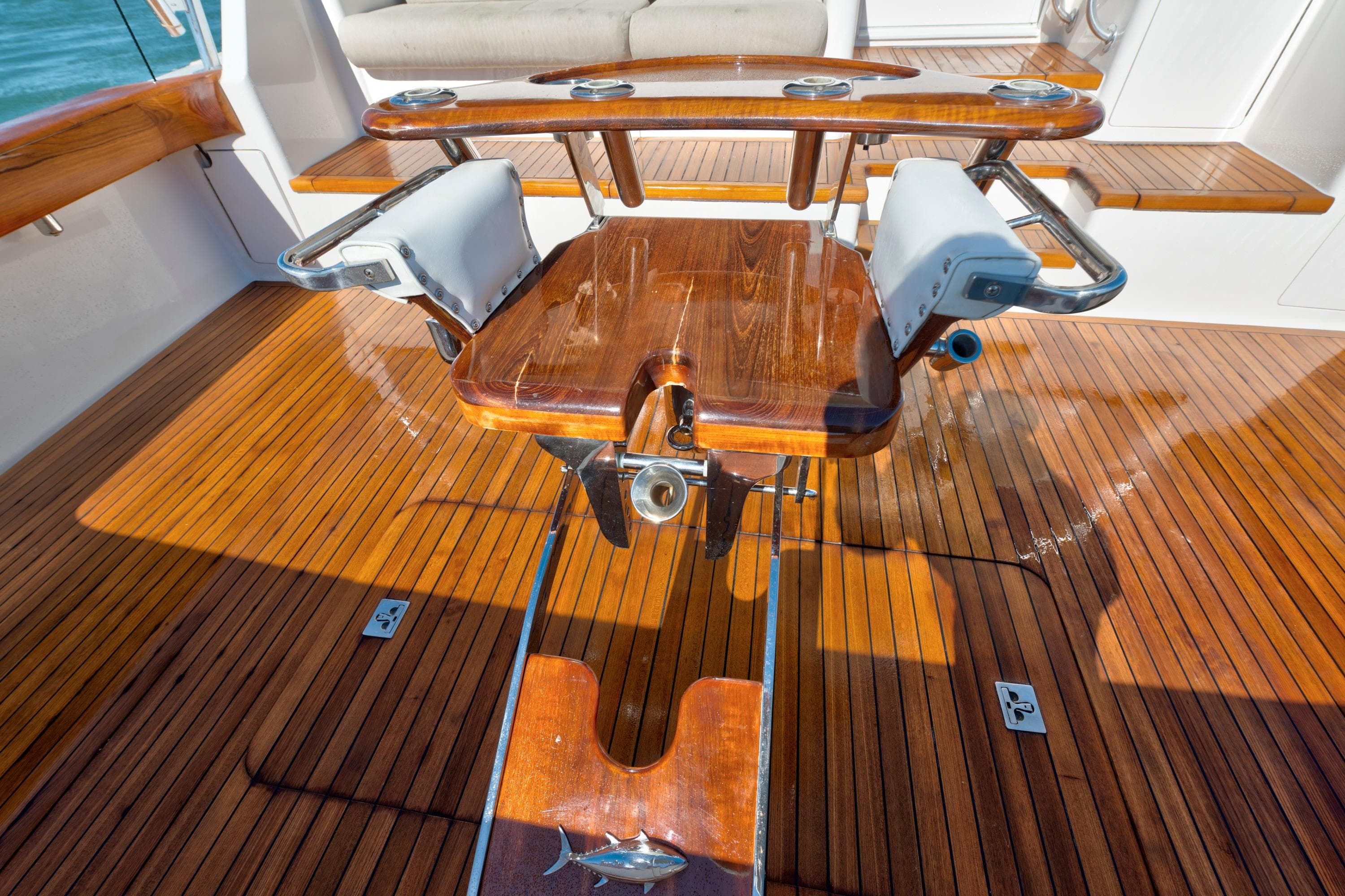 2002 Viking Convertible boat with polished wooden deck and fishing chair.