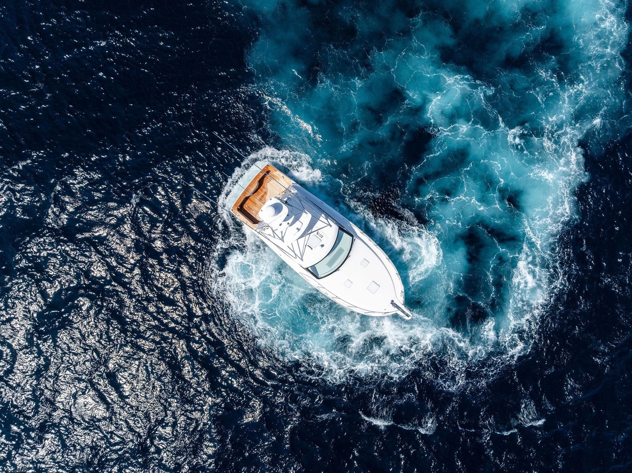 Aerial view of 2016 Hatteras Express Sportfish yacht navigating ocean waters.