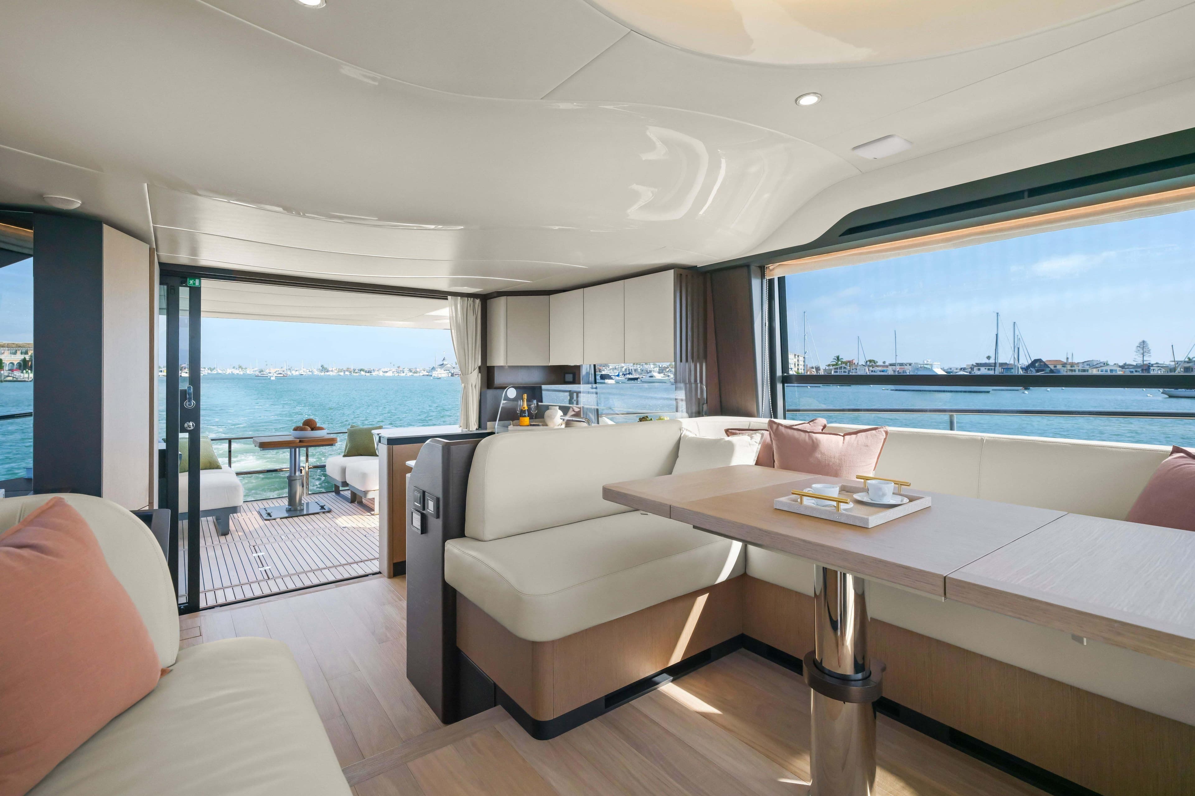 Luxurious interior of 2026 Absolute 52 Fly yacht with ocean view and elegant seating.