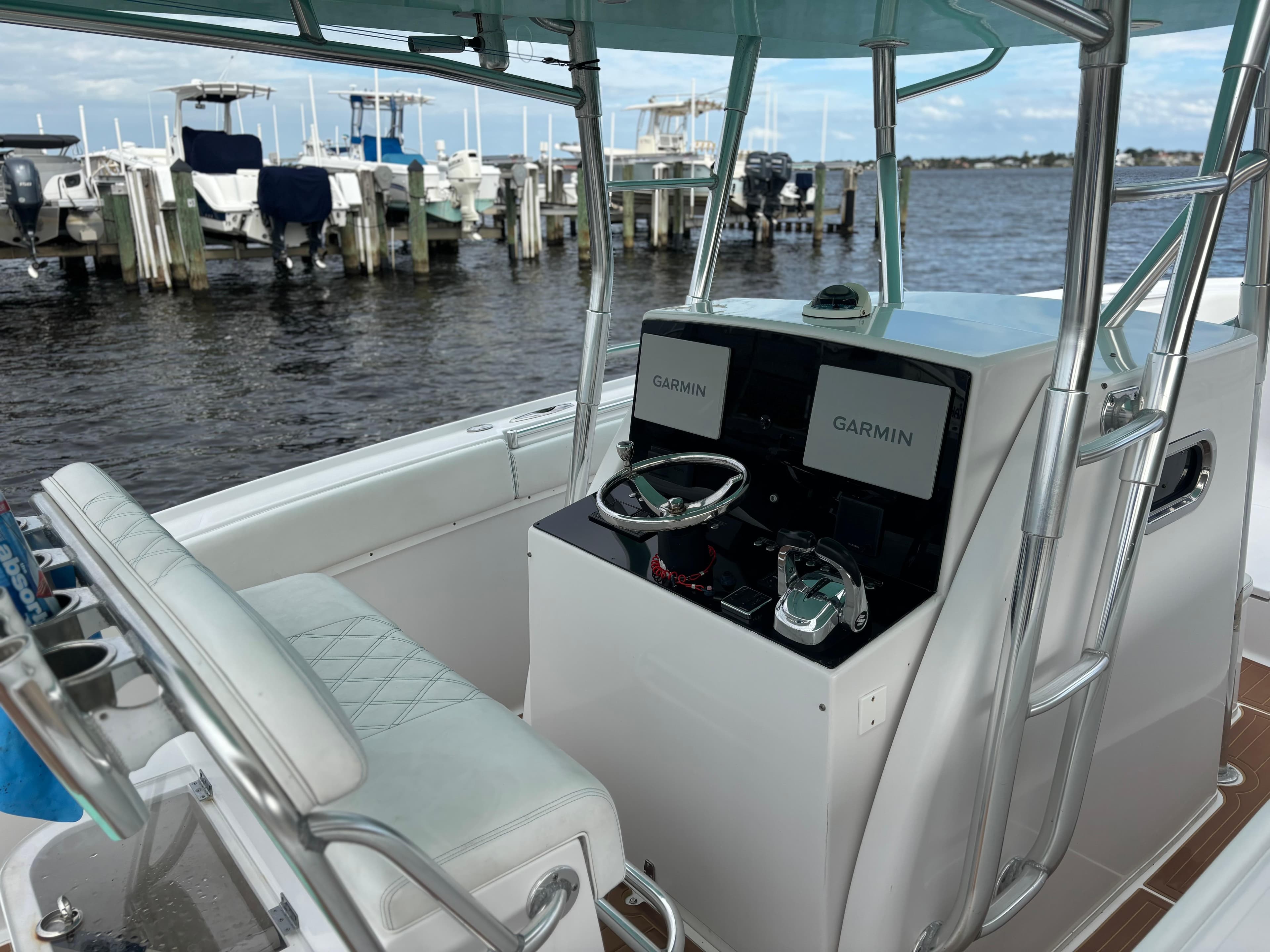 2006 Buddy Davis 34 Center Console boat with Garmin displays at a marina.