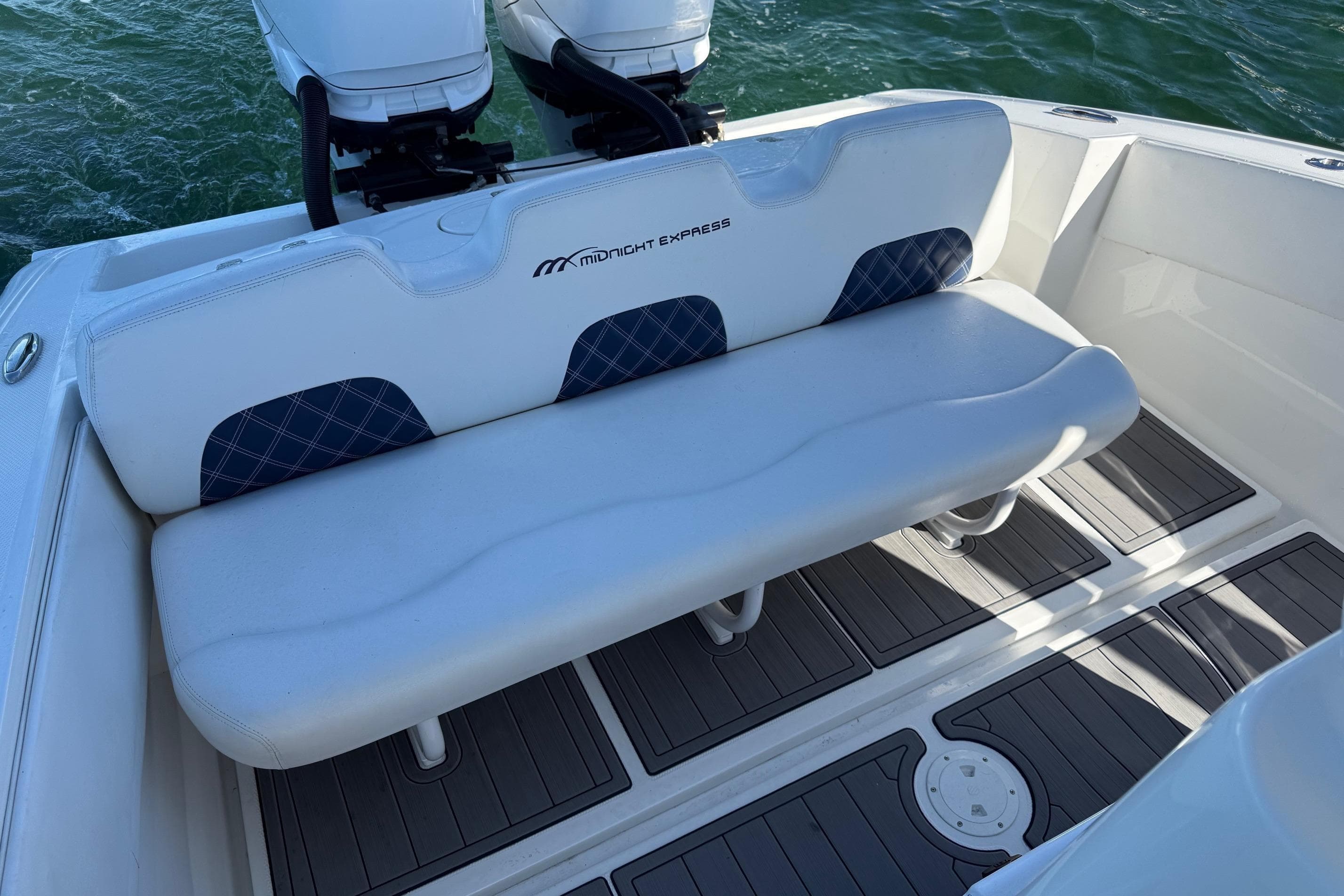 2020 Midnight Express 34 Open boat seating with dual engines on water.