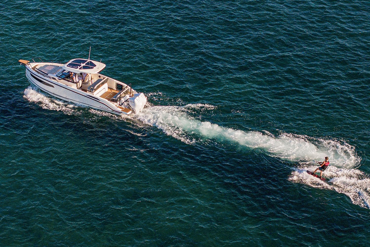Manufacturer Provided Image: Aerial view of Navan S30 boat towing a wakeboarder on open water, 2026 model.