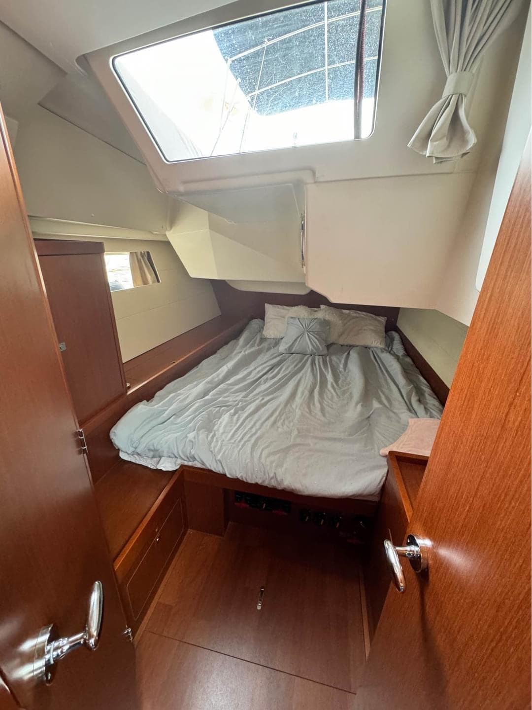 Cozy cabin interior of 2013 Beneteau Oceanis 48 sailboat with skylight and bed.