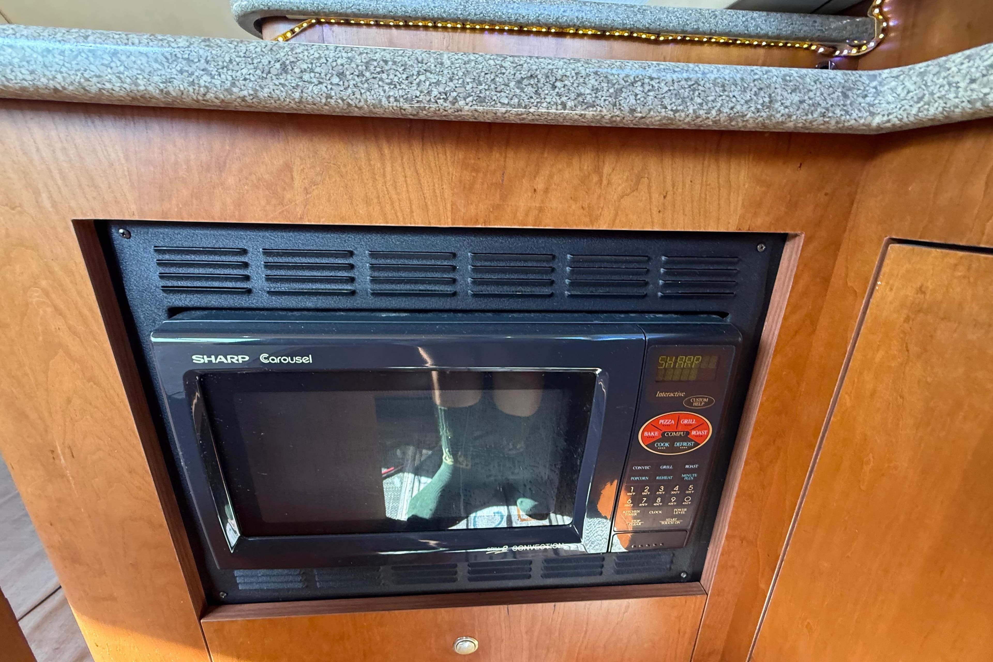 Built-in Sharp Carousel microwave in 2002 Cruisers Yachts 4450 Express Motoryacht kitchen.