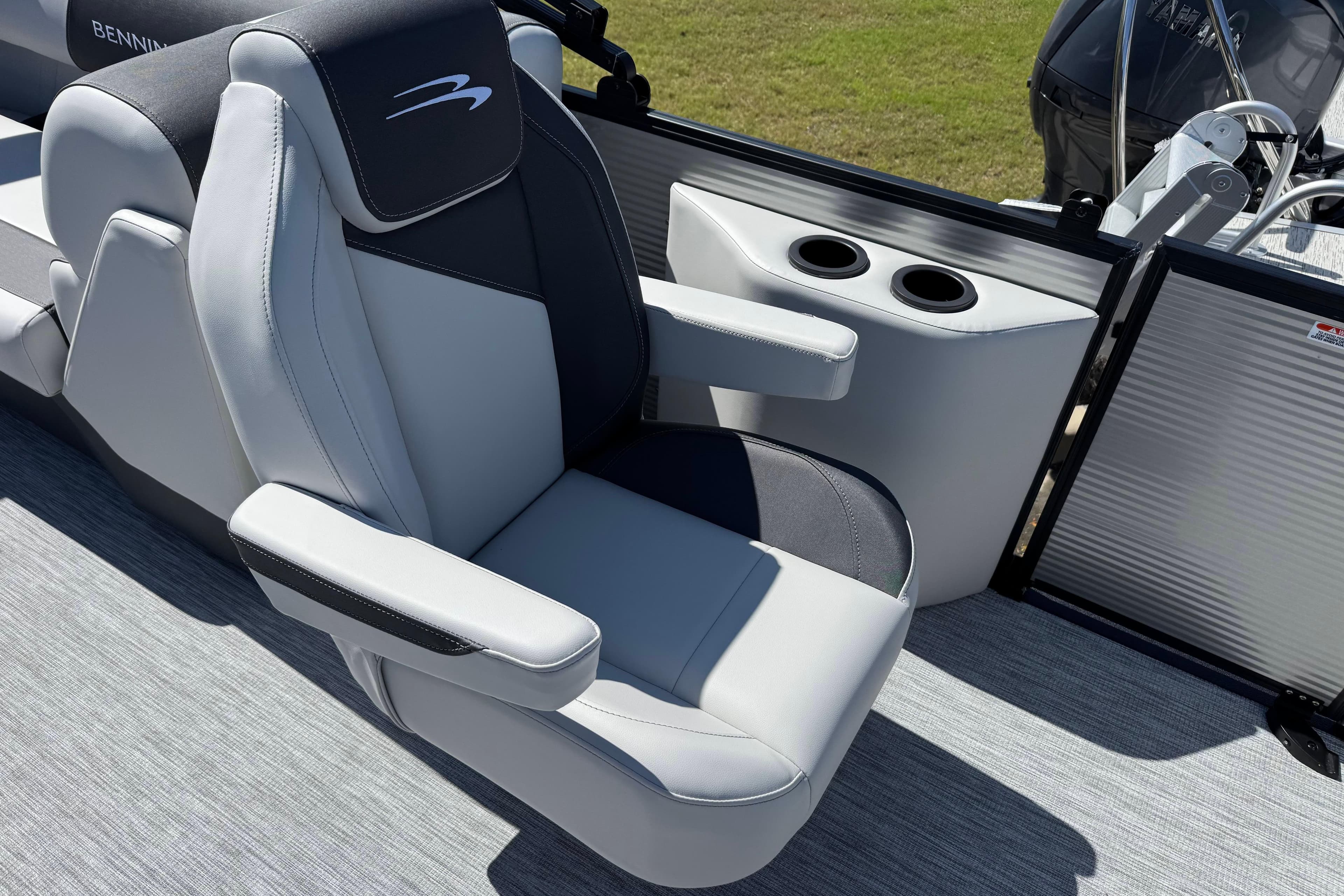 2026 Bennington 22 SSR boat seat with armrests and cup holders, showcasing luxury design.