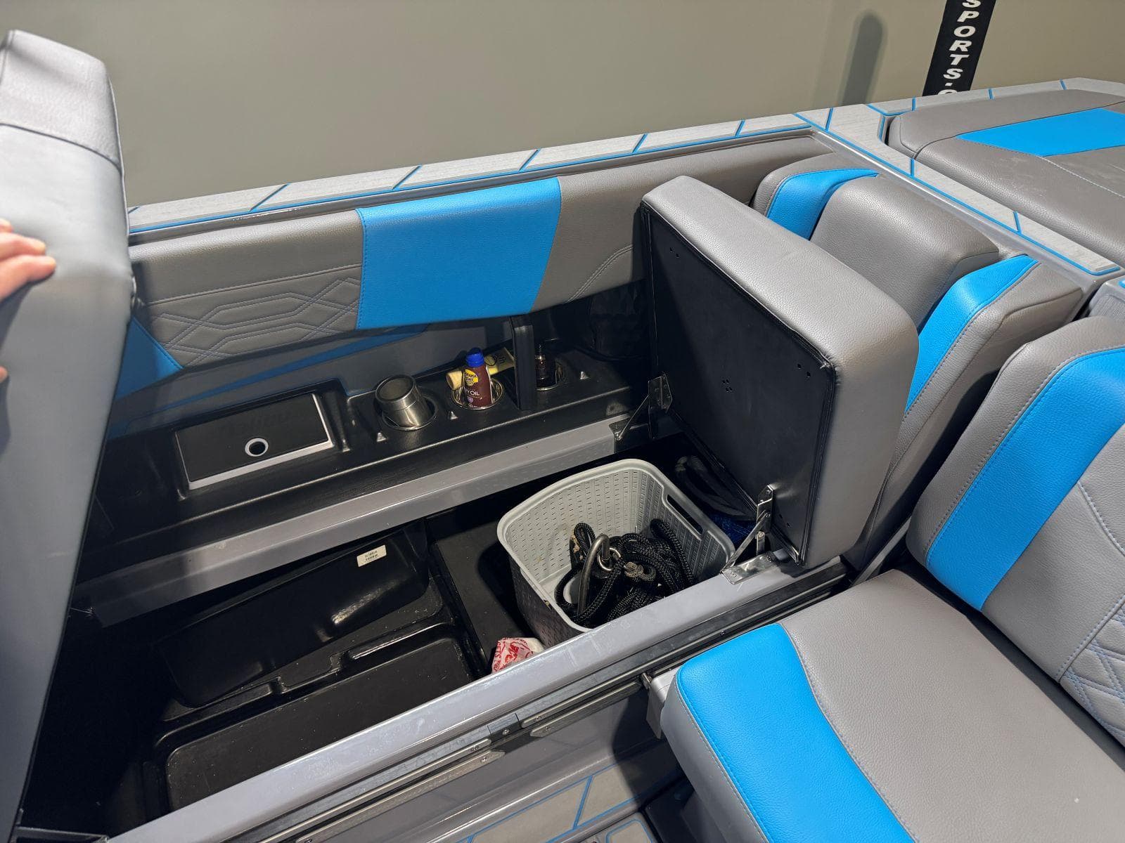 2022 Malibu Wakesetter 25 LSV interior storage with blue and gray seating.