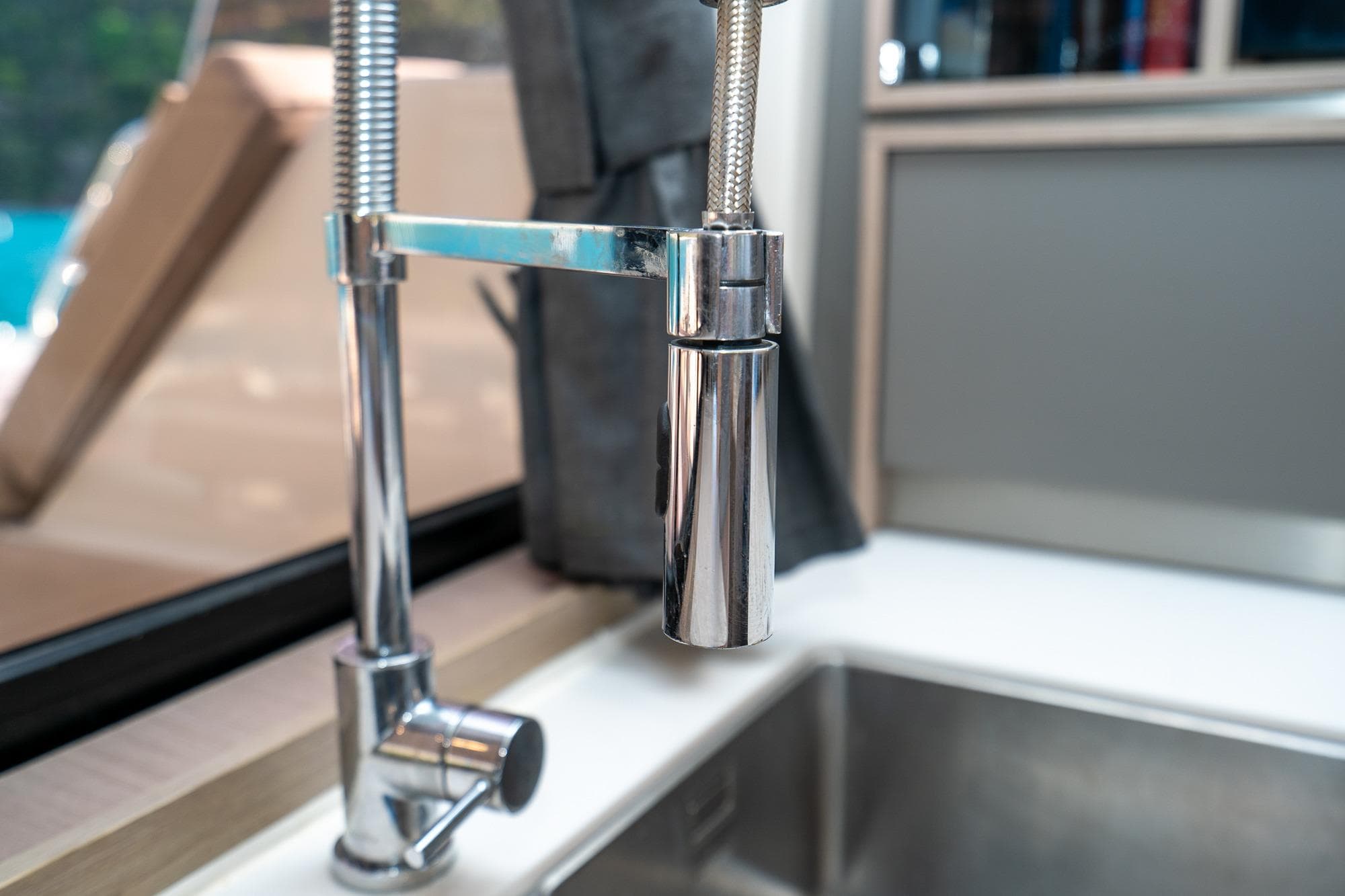 Modern kitchen faucet on 2023 Fountaine Pajot Alegria yacht, featuring sleek chrome design.