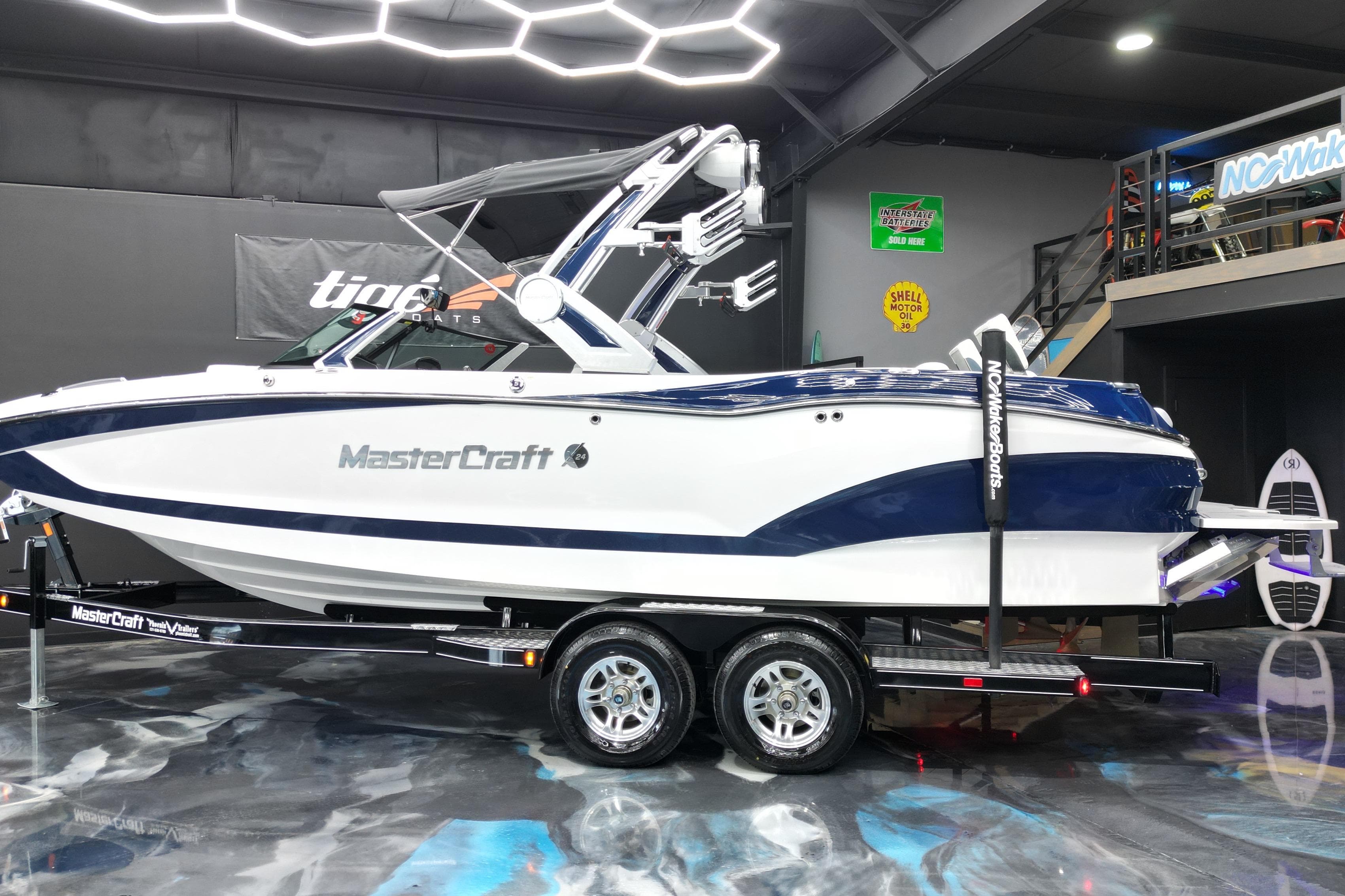 2023 MasterCraft X24 boat displayed indoors on a trailer.