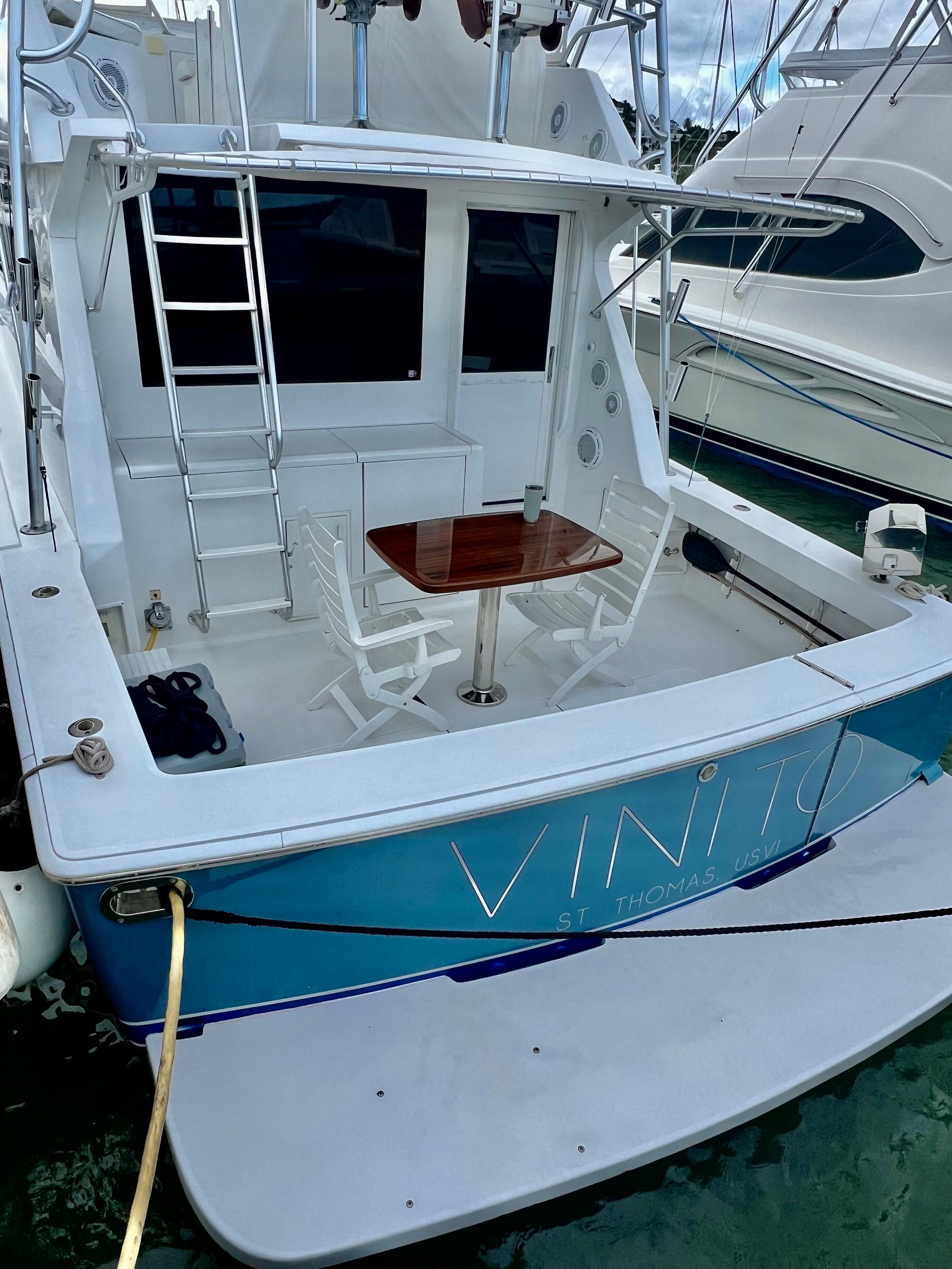 1997 Viking 43 Convertible yacht docked, featuring a rear deck with seating and table.
