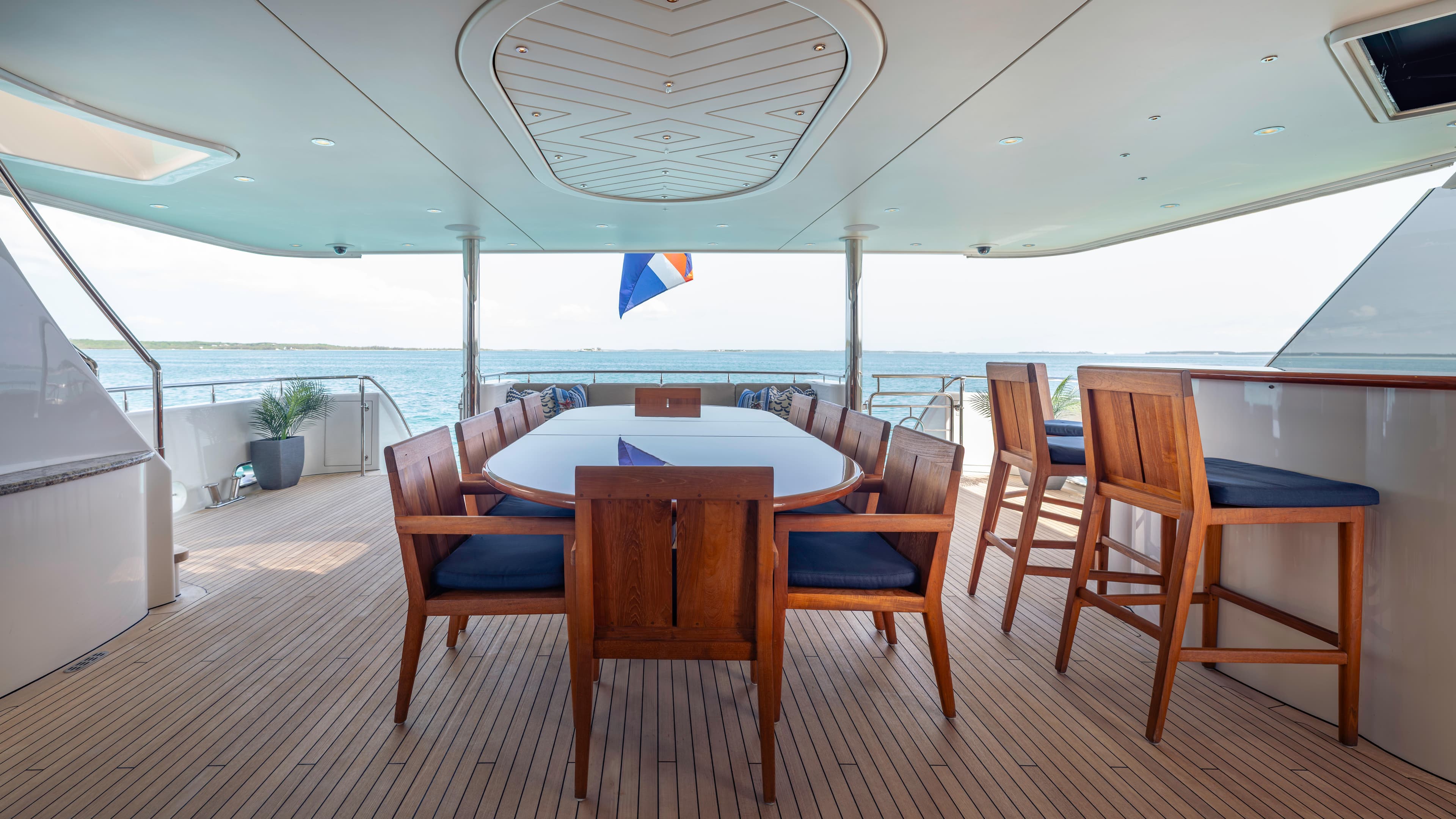 Luxurious 2014 Westport 40M yacht deck with elegant dining area and ocean view.