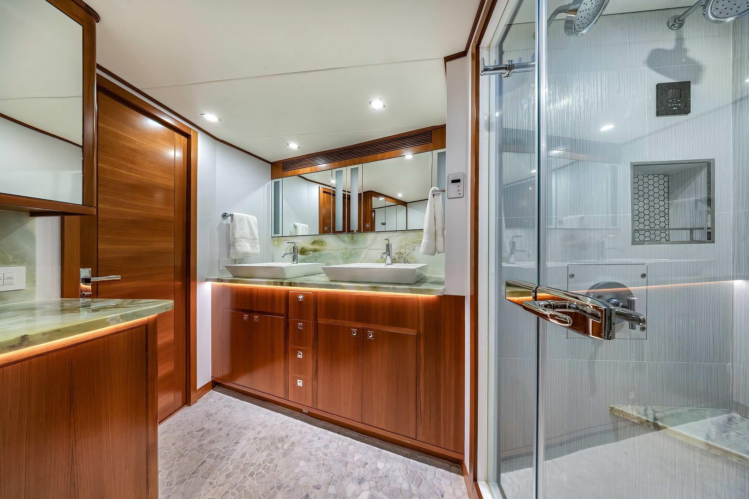 Luxurious bathroom in 2025 Nordhavn 71 yacht with modern fixtures and elegant wood finishes.