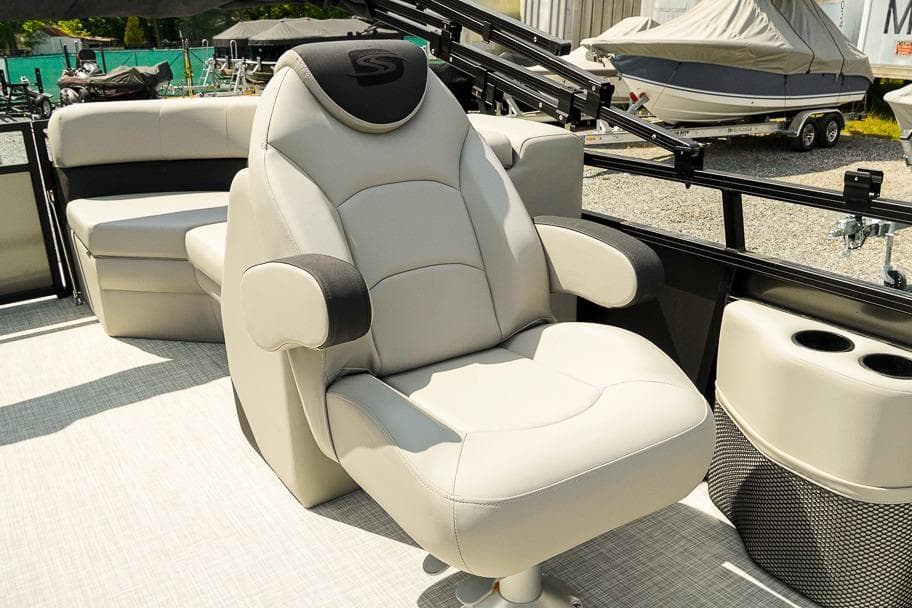 Luxurious seating on 2026 Dockside Pontoons 22DQ boat, featuring plush captain's chair.