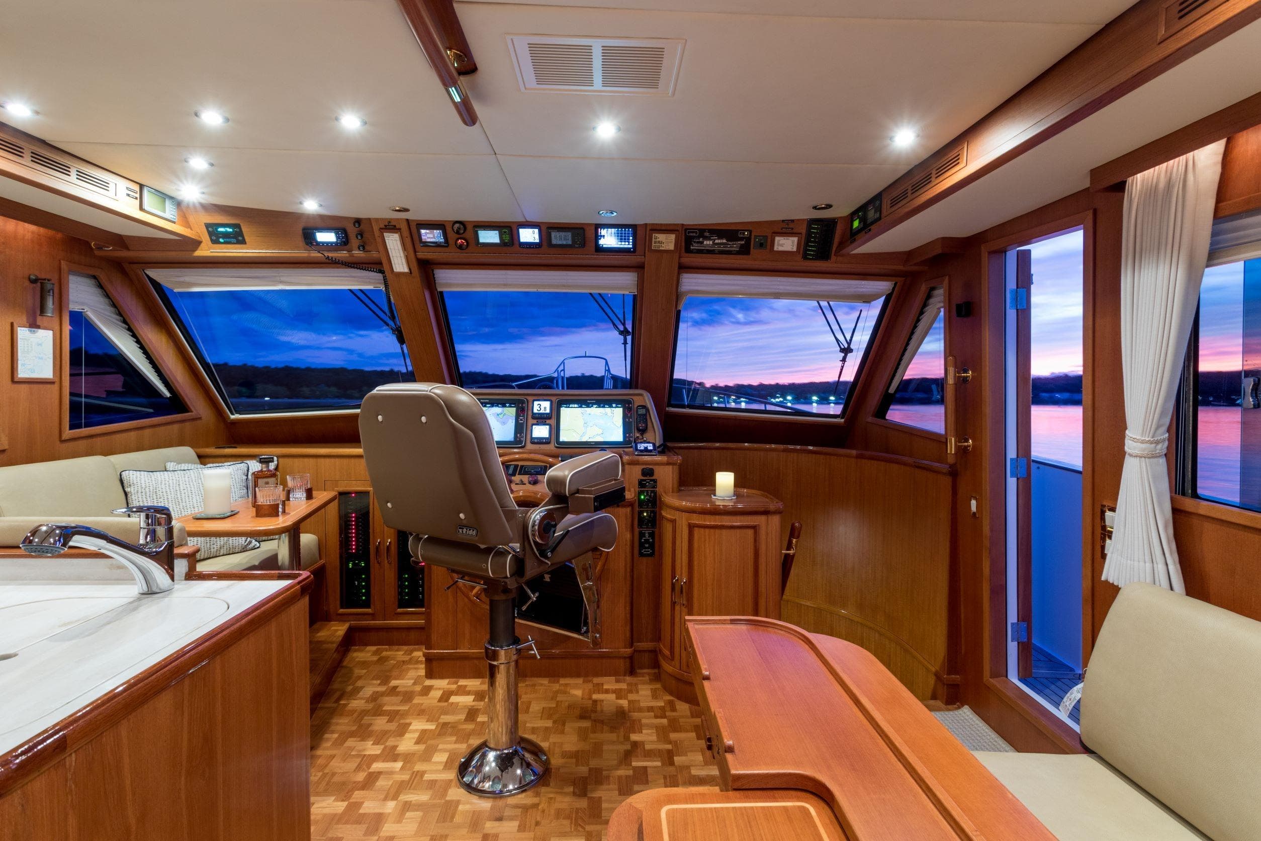 Luxurious 2006 Grand Banks 59 Aleutian RP yacht interior with sunset view.