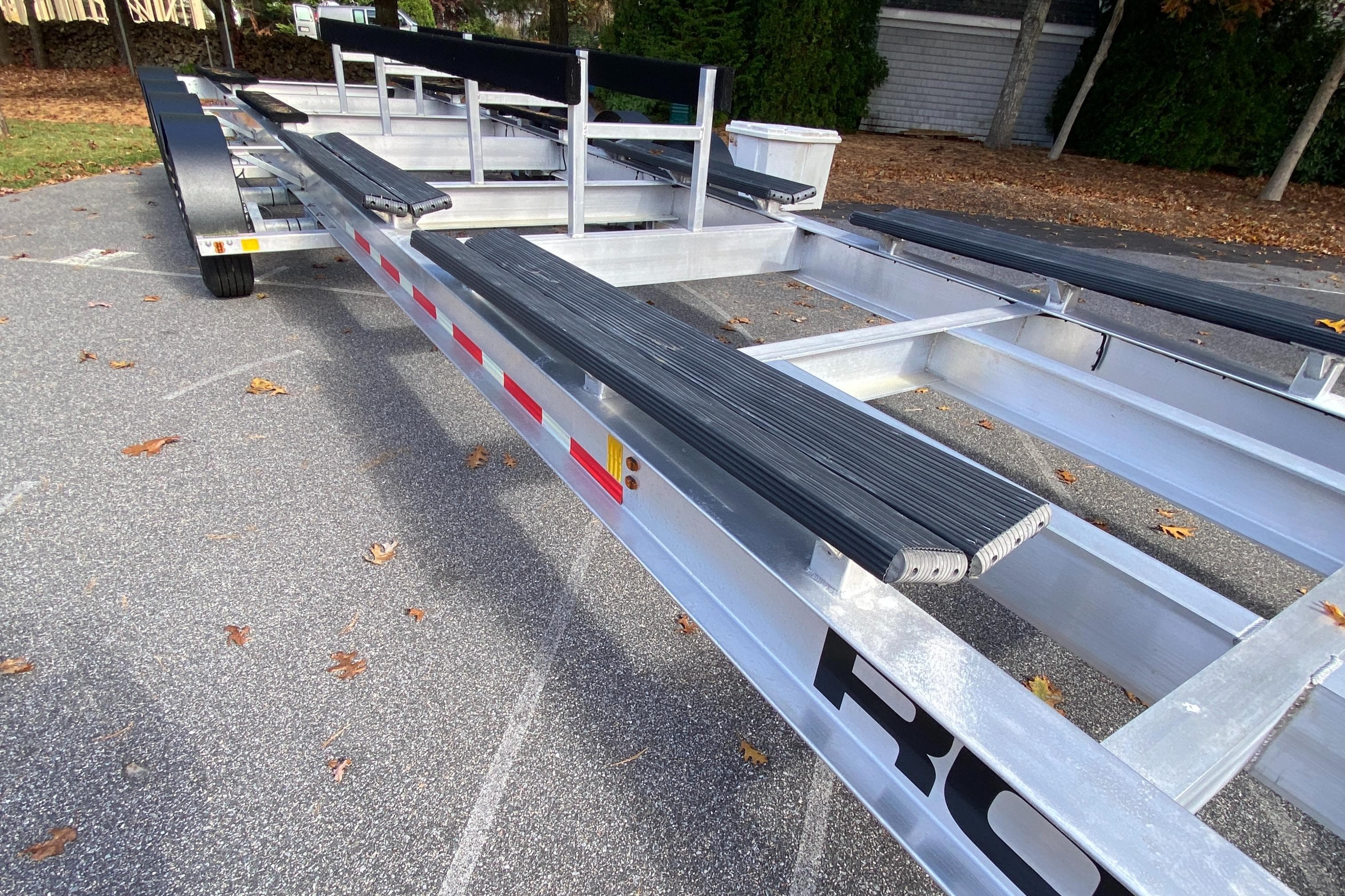 2023 Invincible 46 Catamaran Plus Quad Axle Trailer, sturdy design, parked outdoors.