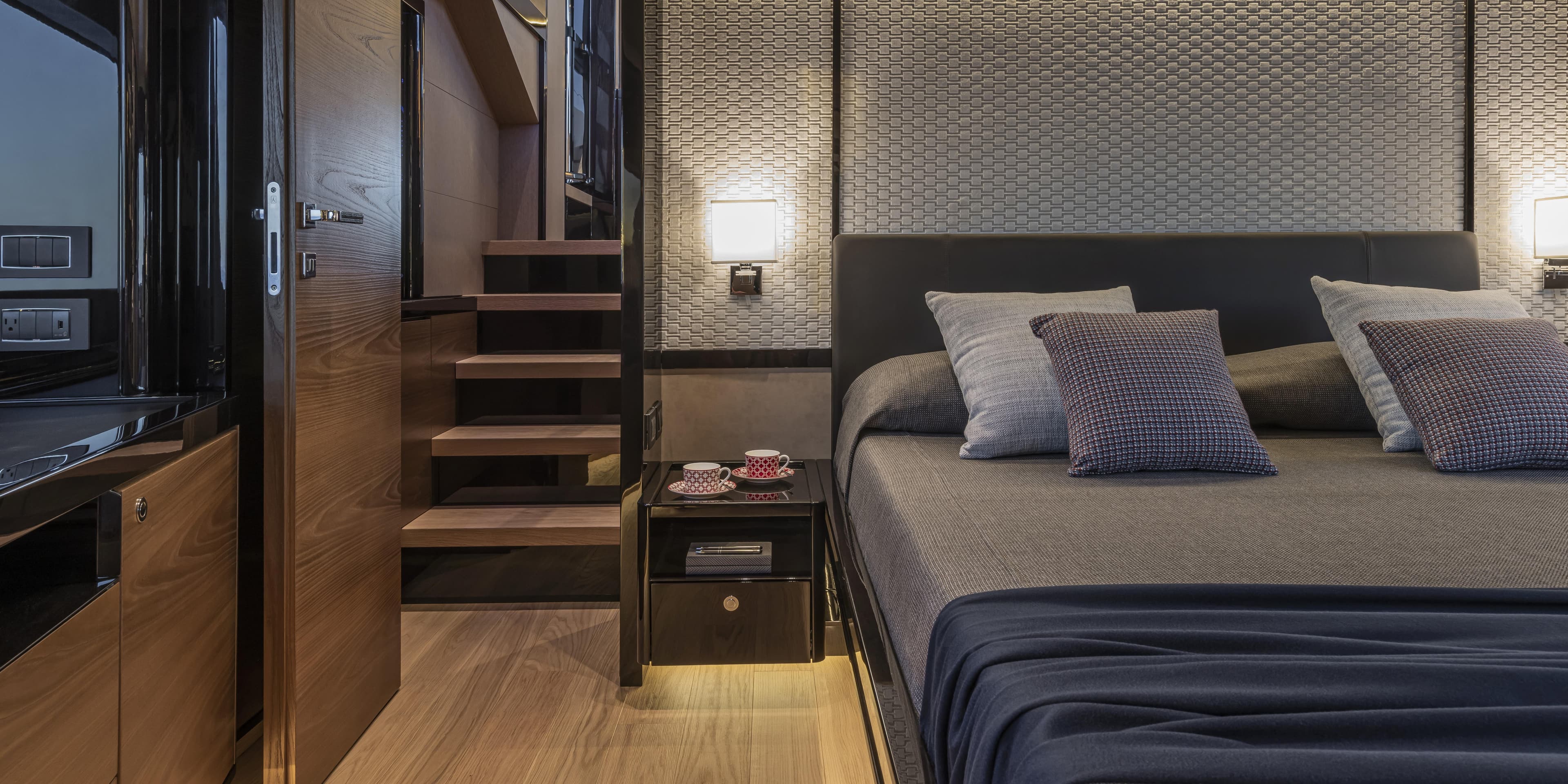 Luxurious bedroom interior of 2025 Absolute NAVETTA 75 yacht with modern design and cozy ambiance.