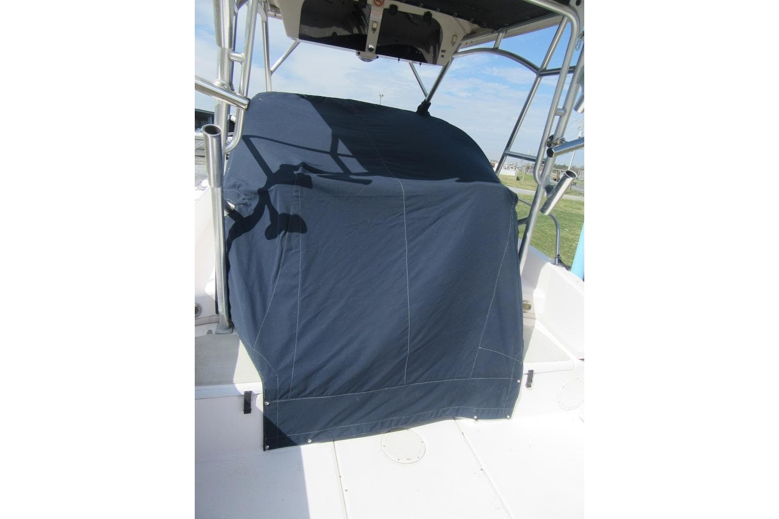 2004 Grady-White Seafarer 228 boat with covered console, outdoor setting.