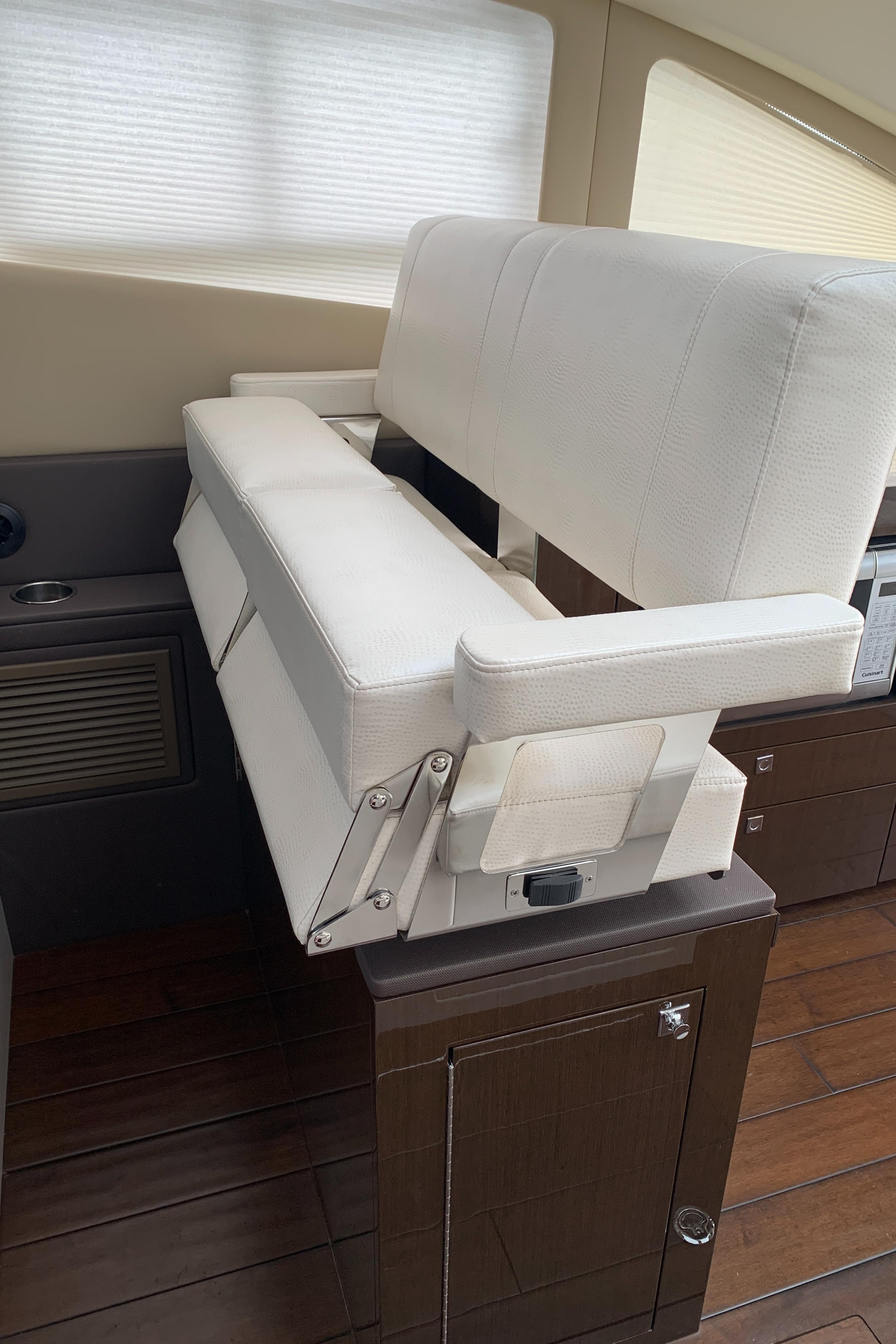 Interior seating of a 2020 Carver C37 Coupe yacht with white upholstery.