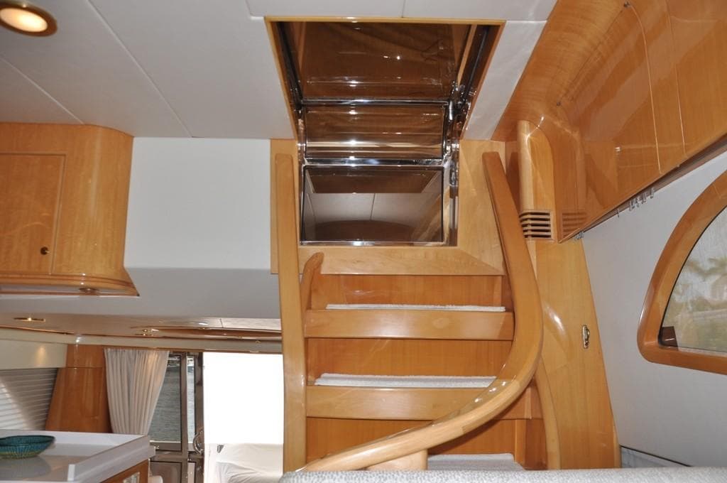 Interior of 2003 McKinna 58 yacht with wooden staircase and modern design.