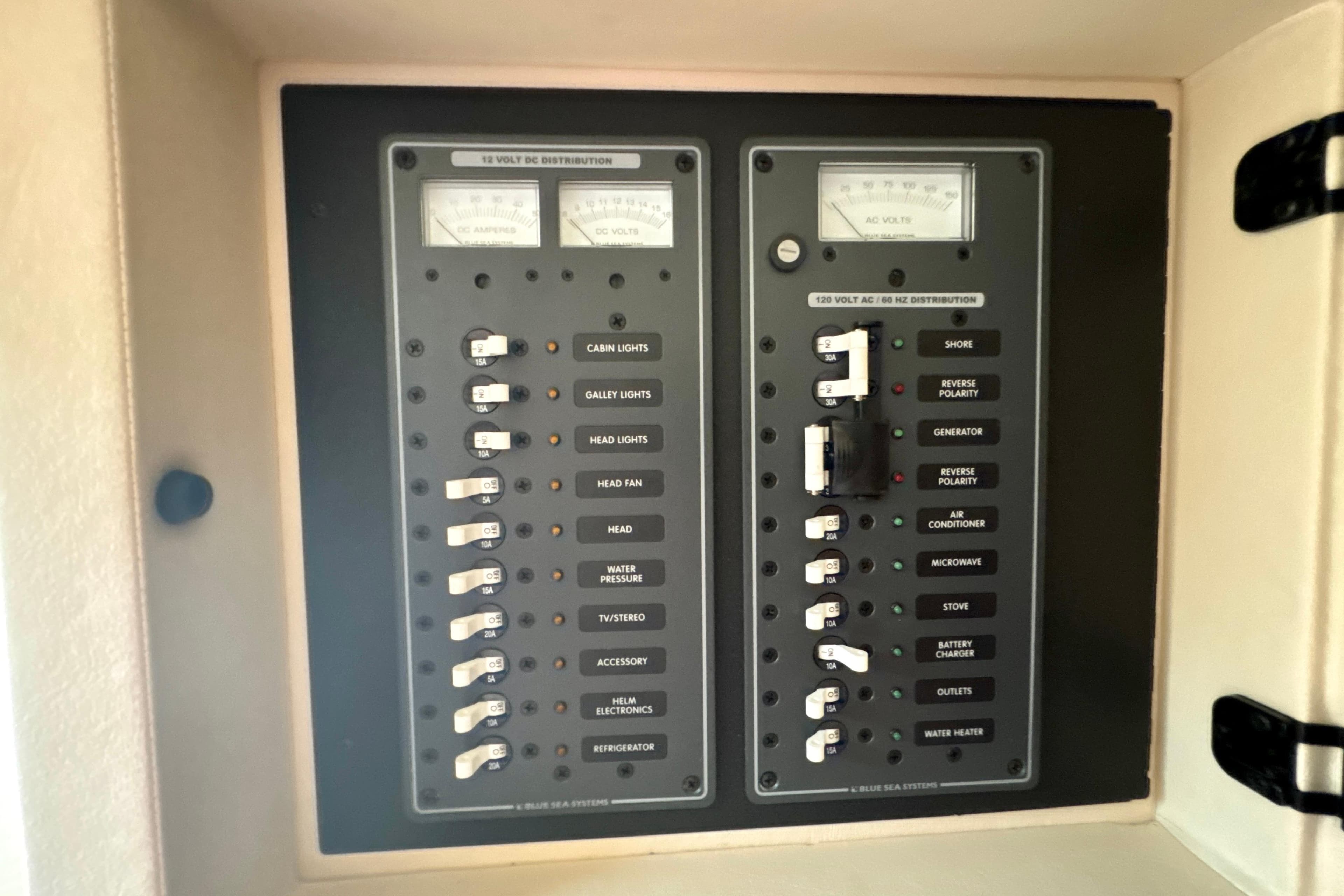 Electrical panel of a 2008 Cobalt 323 boat, featuring DC and AC distribution controls.