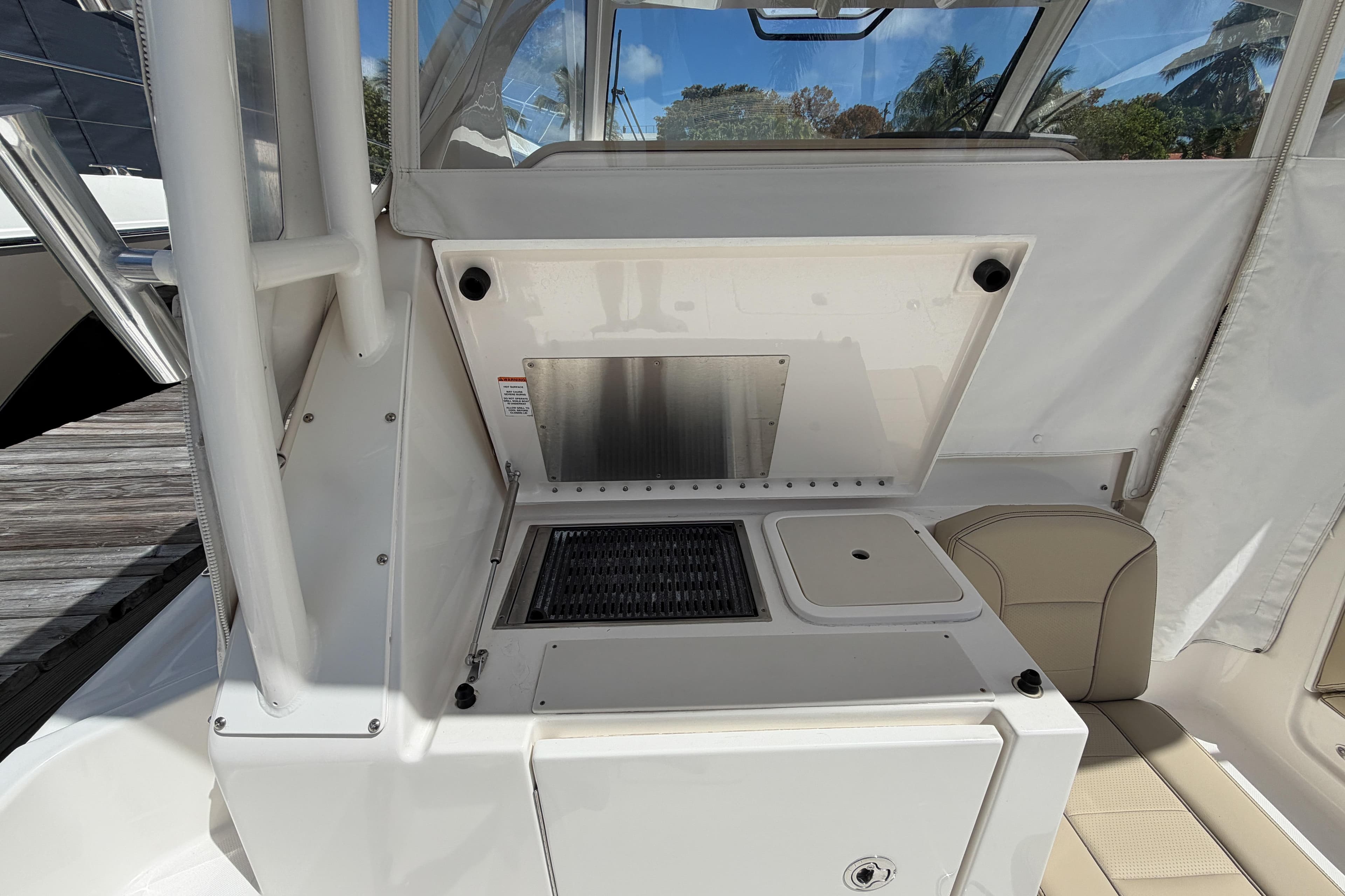 2018 Pursuit OS 355 Offshore boat interior with kitchenette and seating area.