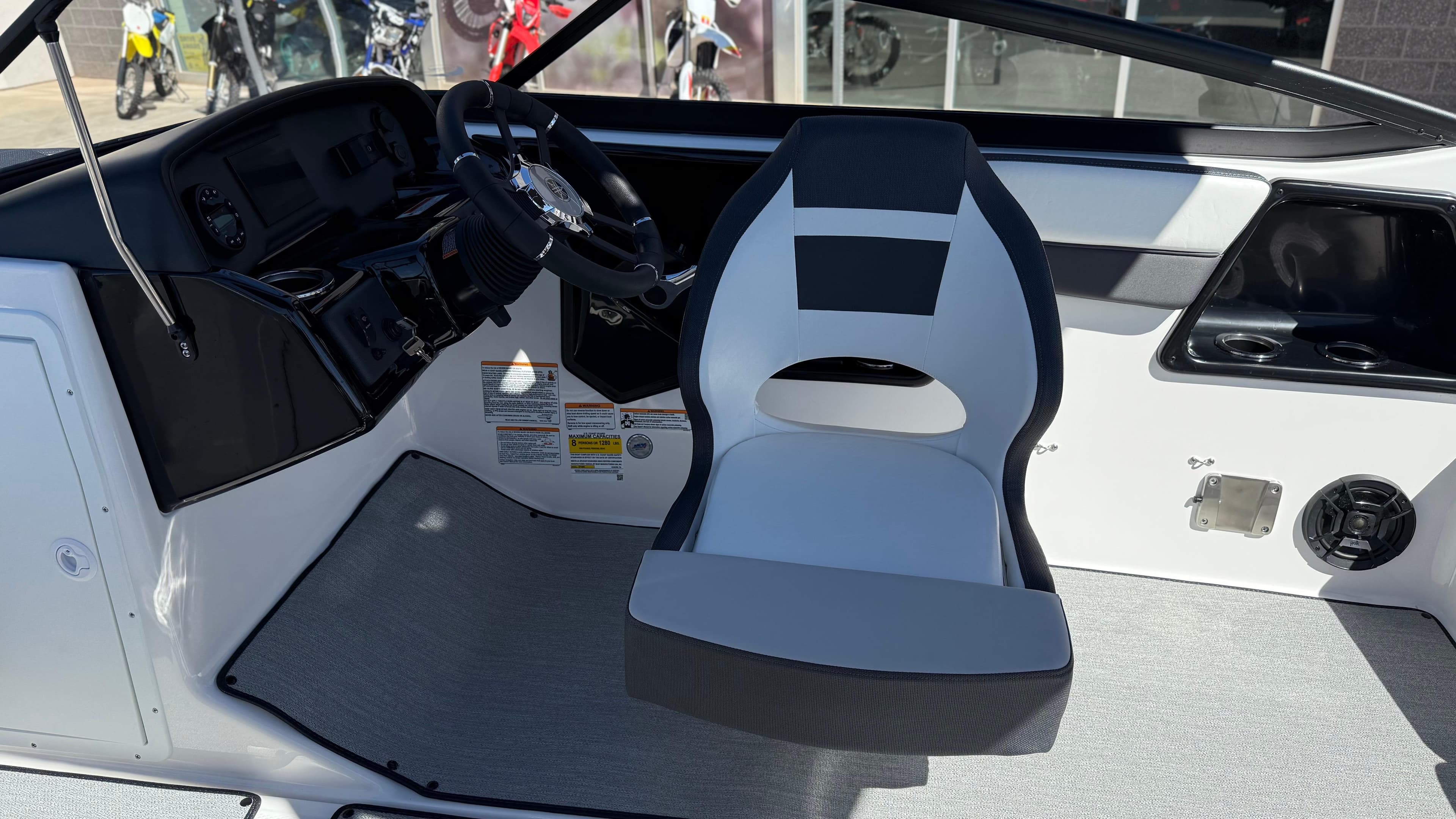 2025 Yamaha AR195 boat interior with steering wheel and captain's seat.