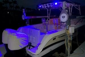 2004 Pro-Line 30 Express boat with blue LED lights at night.