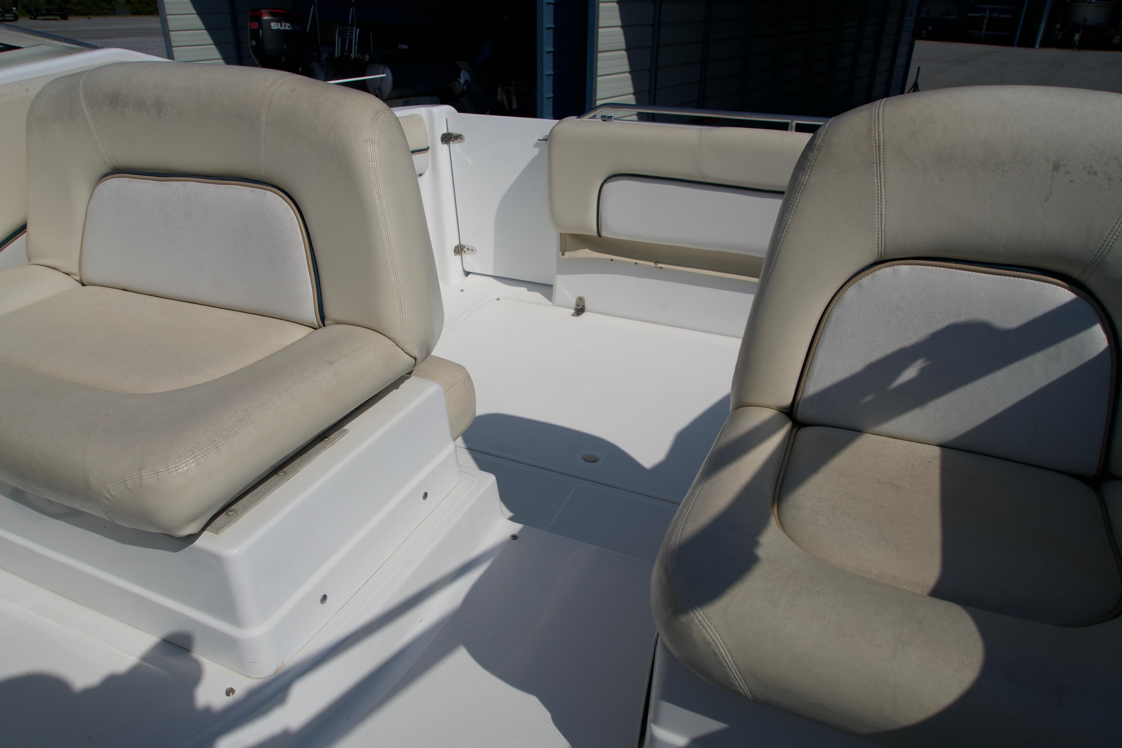2000 Chris-Craft boat interior with beige seating and white deck.