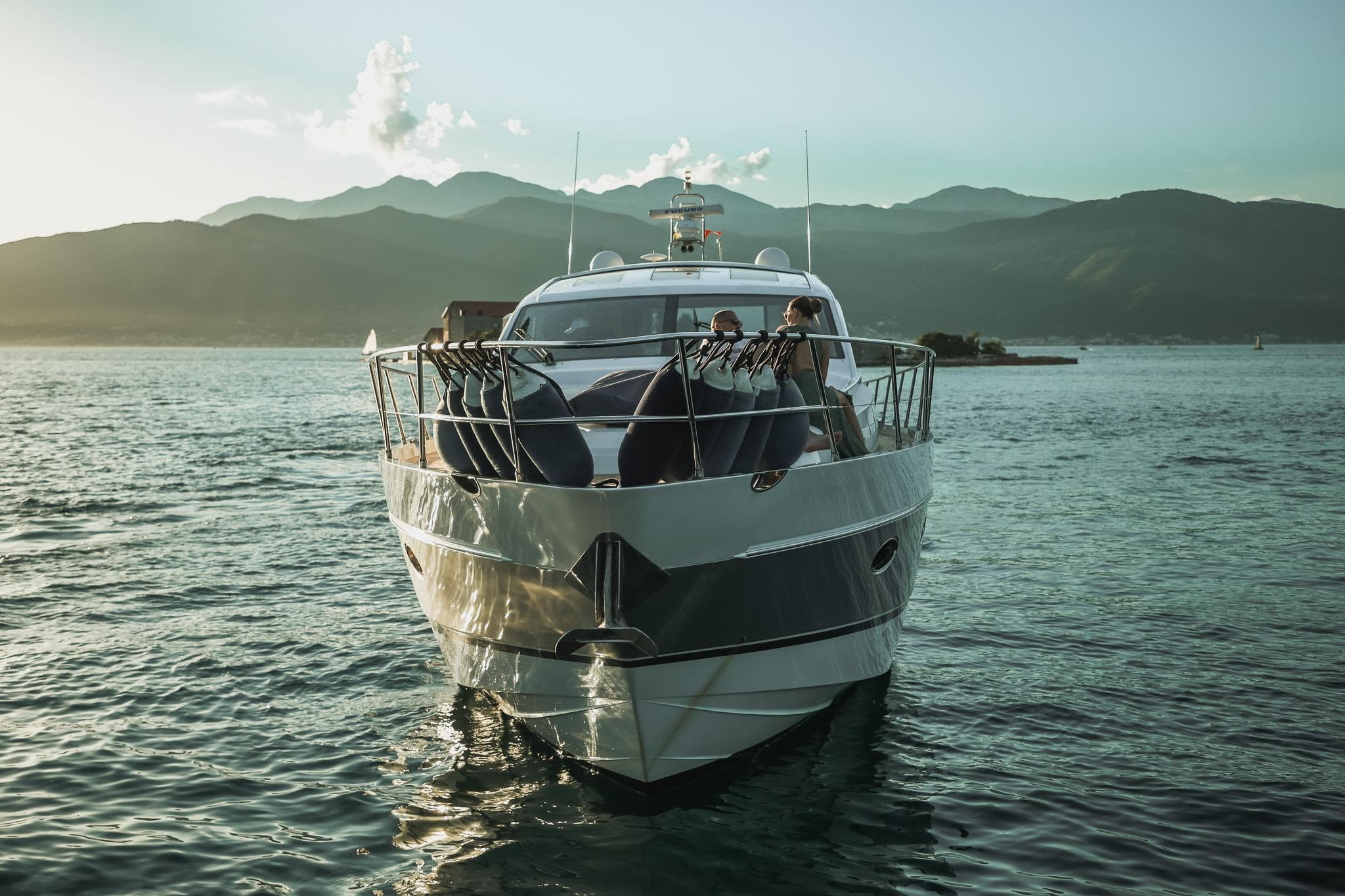 Luxurious 2008 Princess V65 yacht cruising on serene waters at sunset.