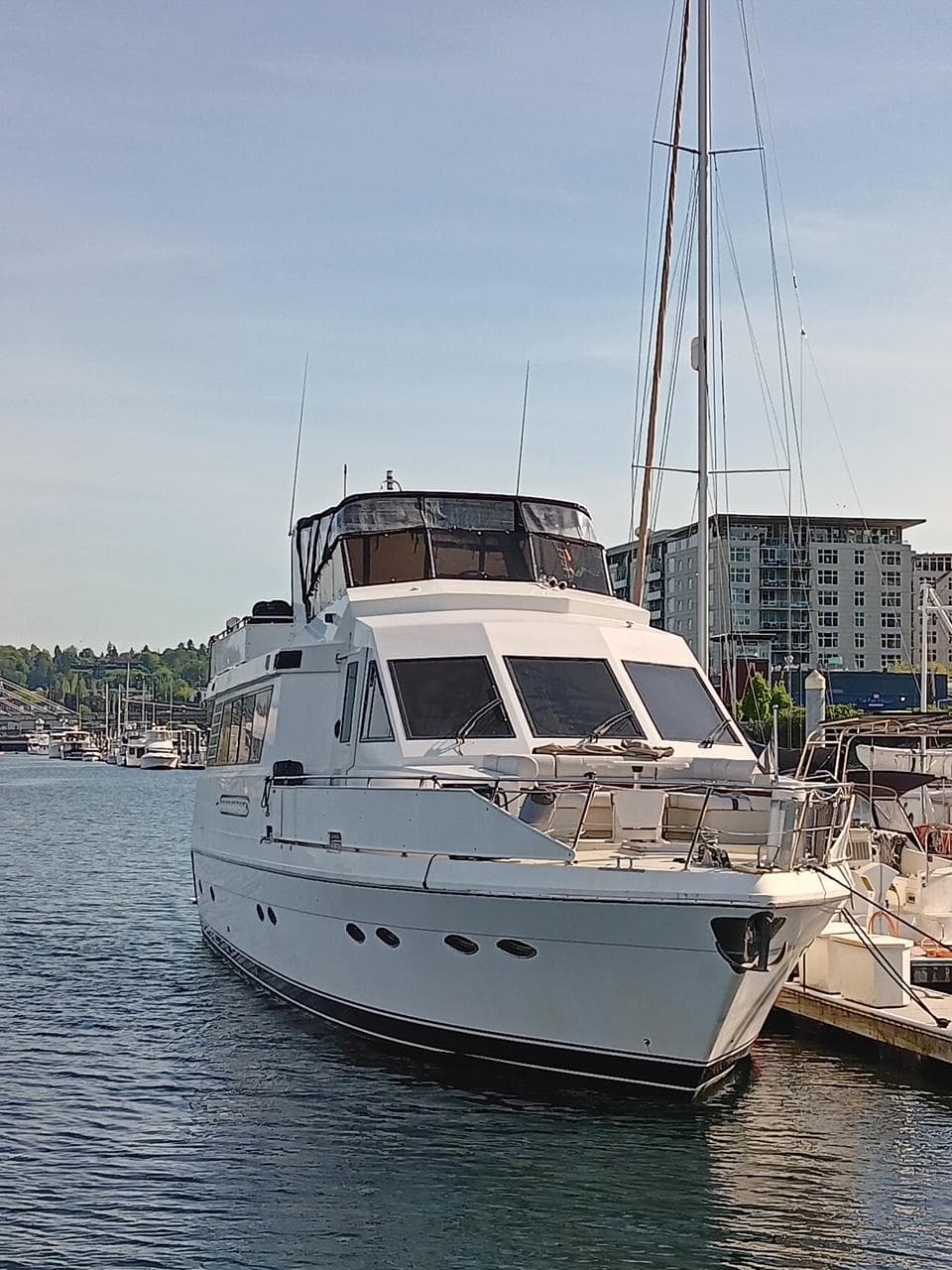 1993 Kha Shing Motoryacht docked in a marina, surrounded by water and buildings.