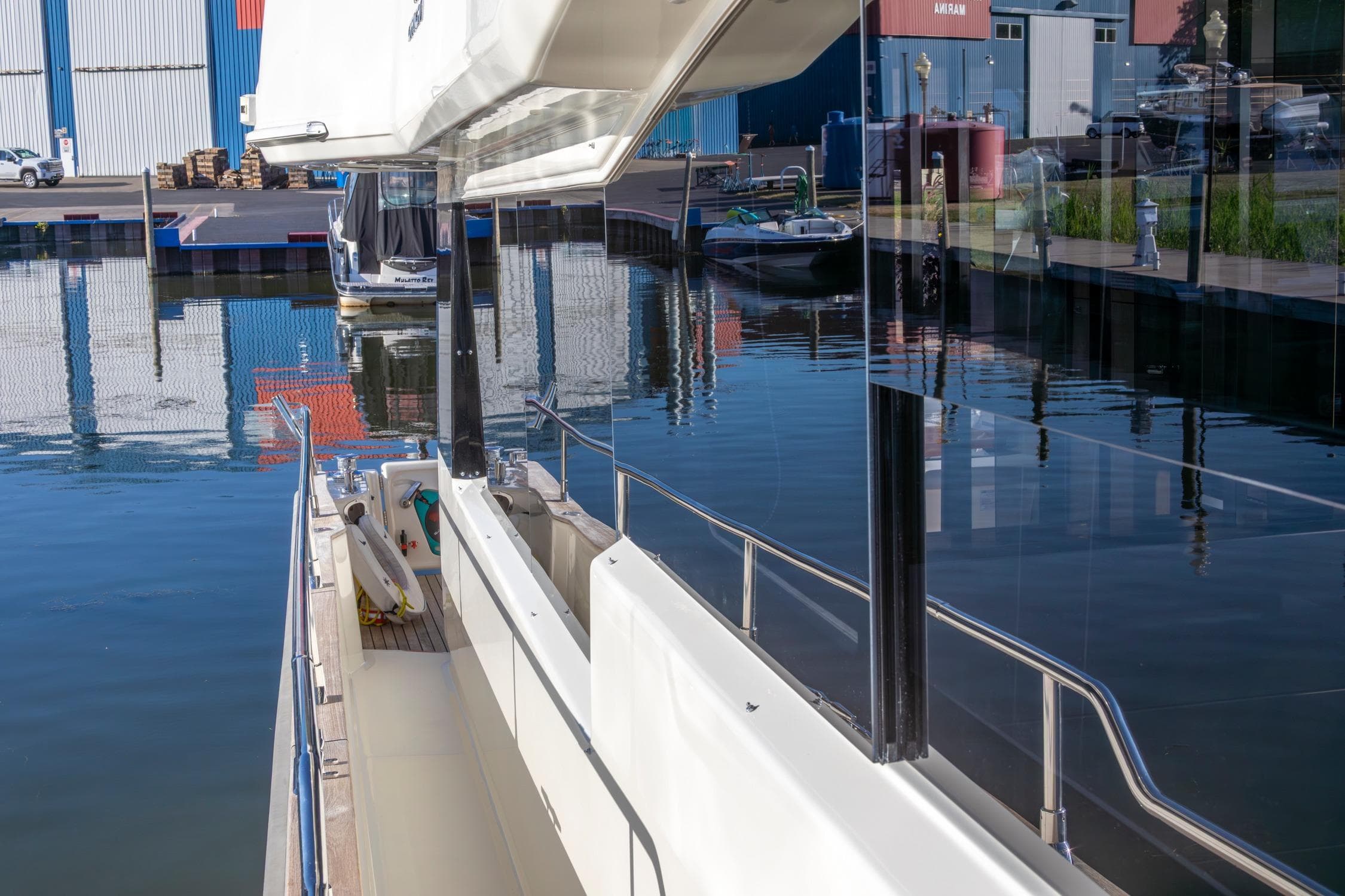 2018 Cranchi Eco Trawler 53 Long Distance docked at marina, reflecting on calm water.