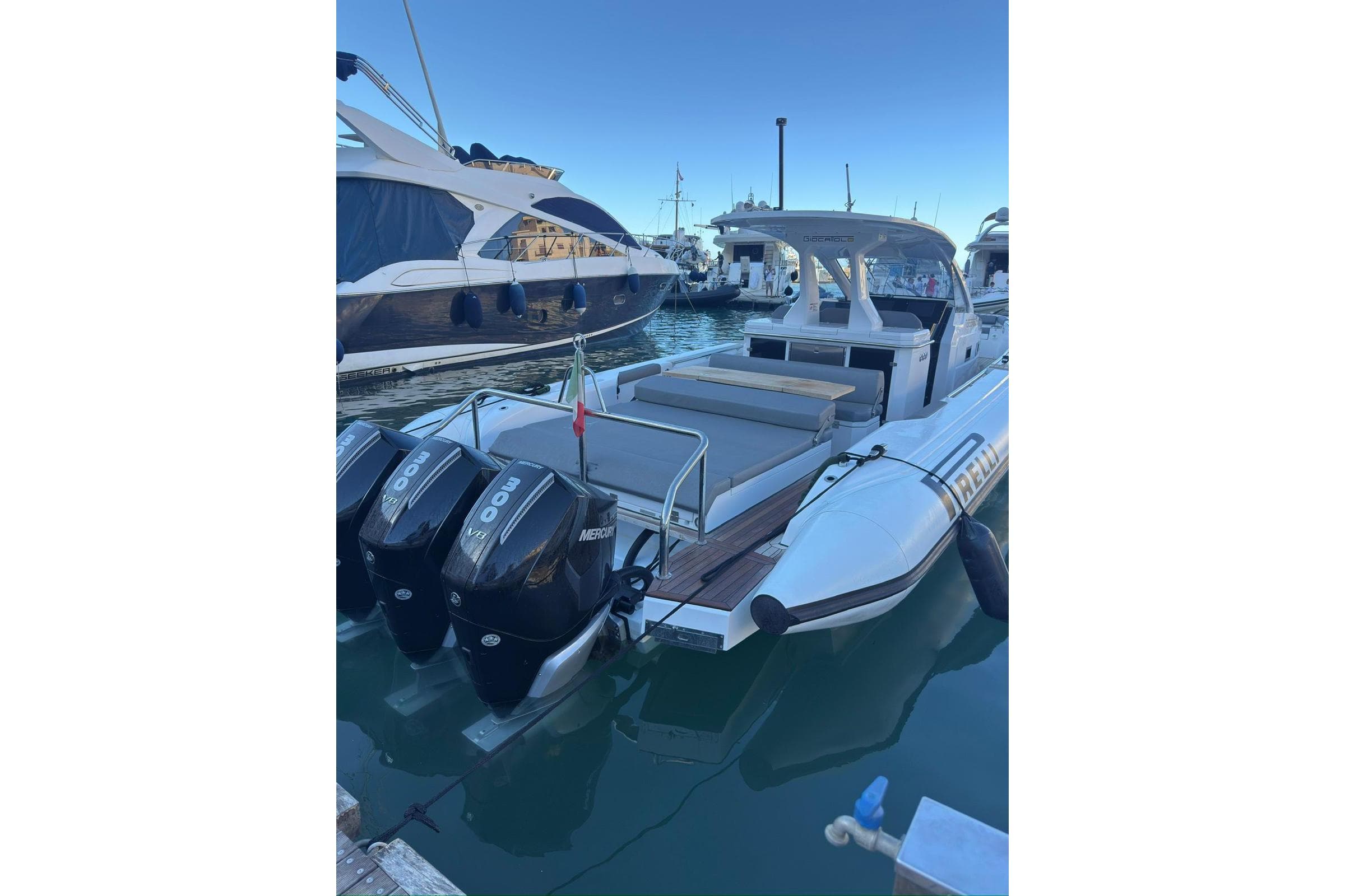 2024 Pirelli 42 boat docked with twin Mercury engines in a marina.
