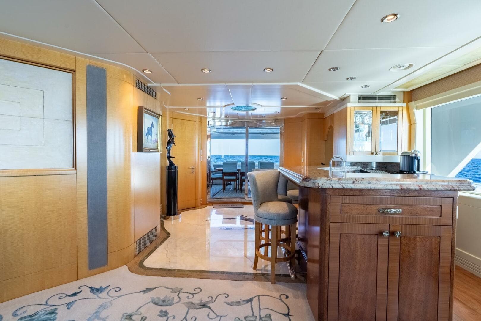 Luxurious interior of 2001 Delta Marine Tri-Deck yacht with elegant bar and ocean view.