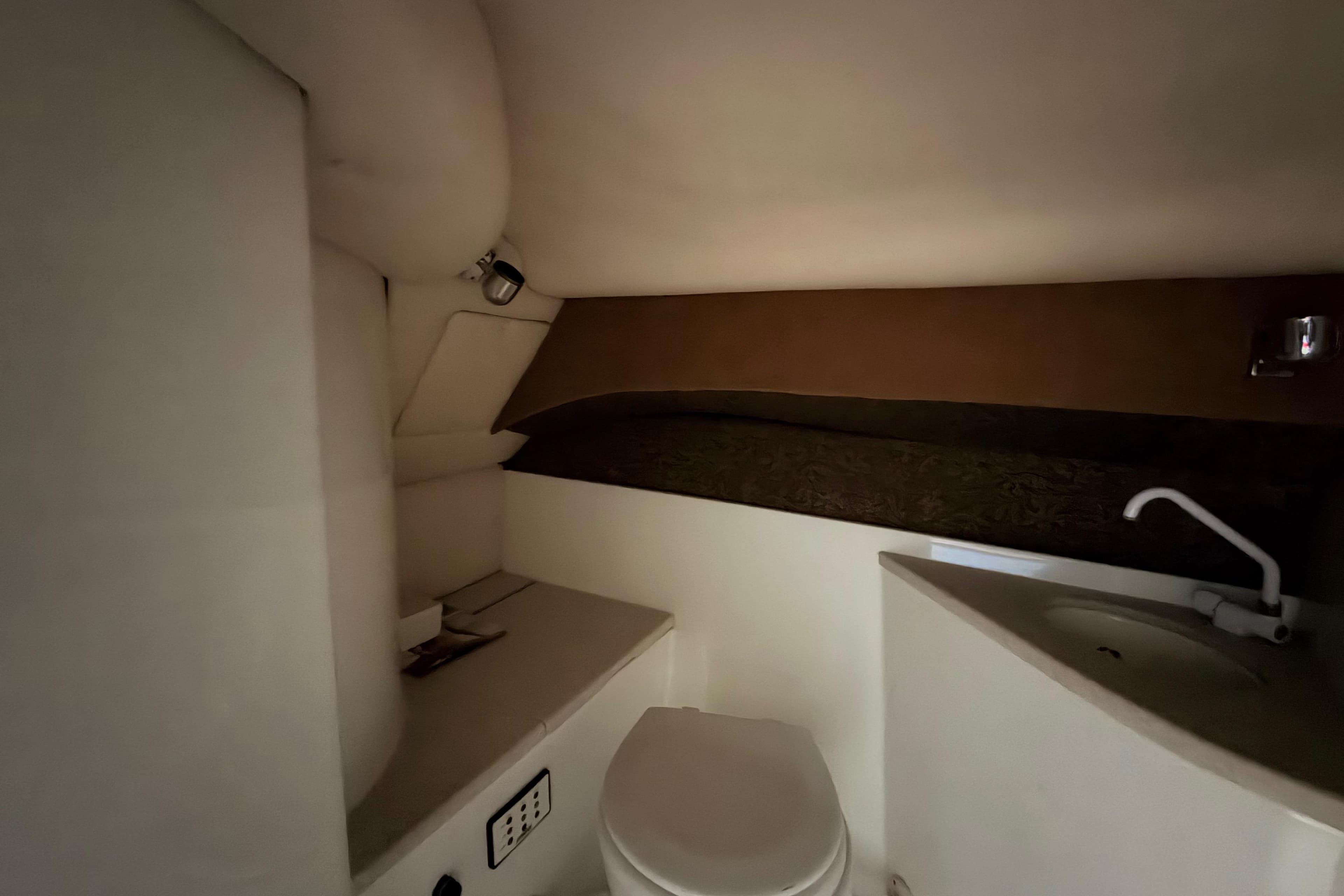 Interior of 2004 Cobalt 343 boat bathroom with toilet and sink.