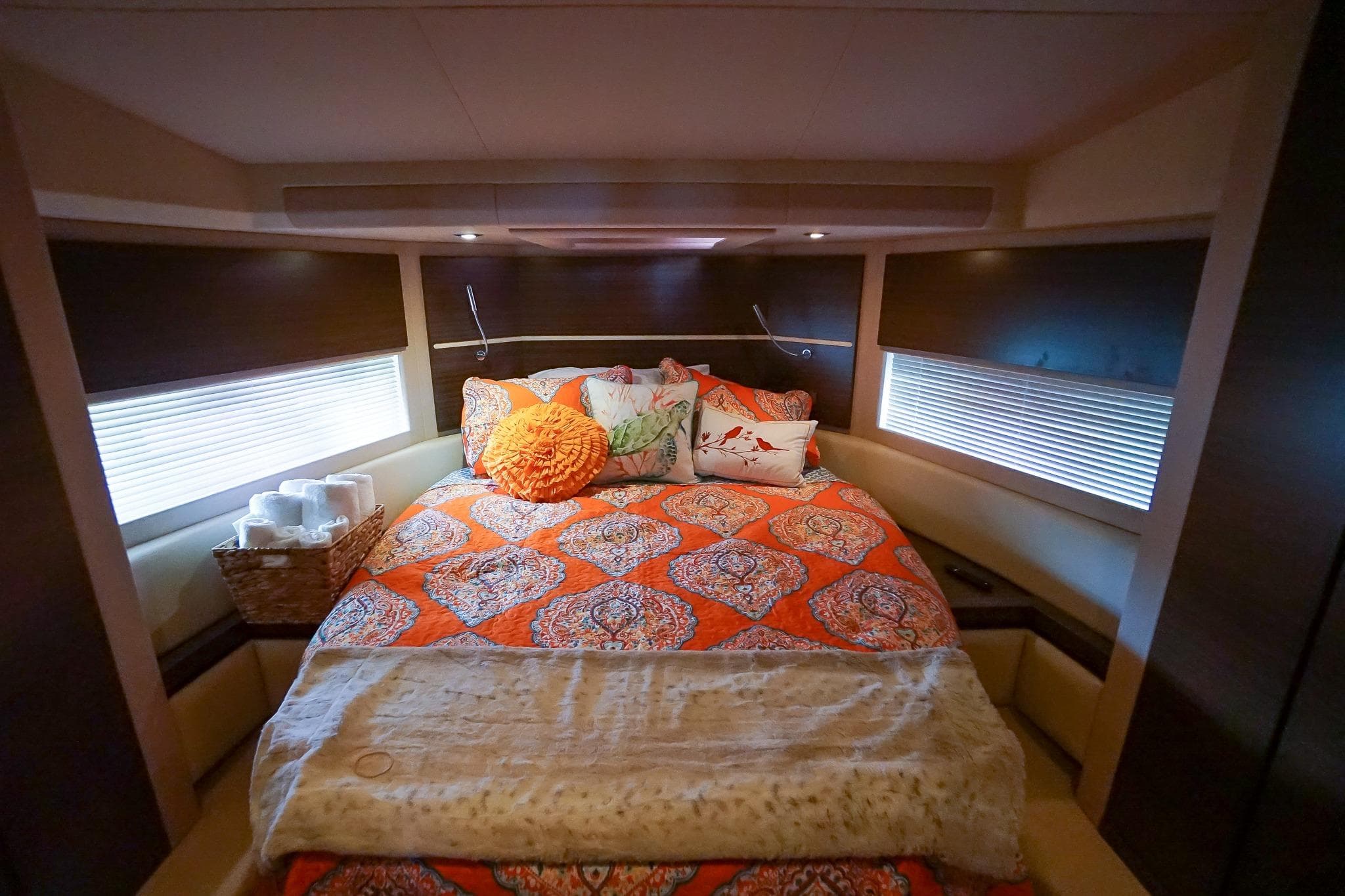 Luxurious bedroom interior of 2014 Azimut 54 Flybridge yacht with vibrant bedding.