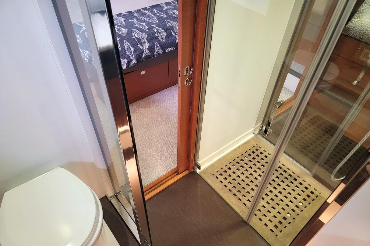 Bathroom and bedroom interior of a 2014 Prestige 550 yacht, featuring modern design elements.