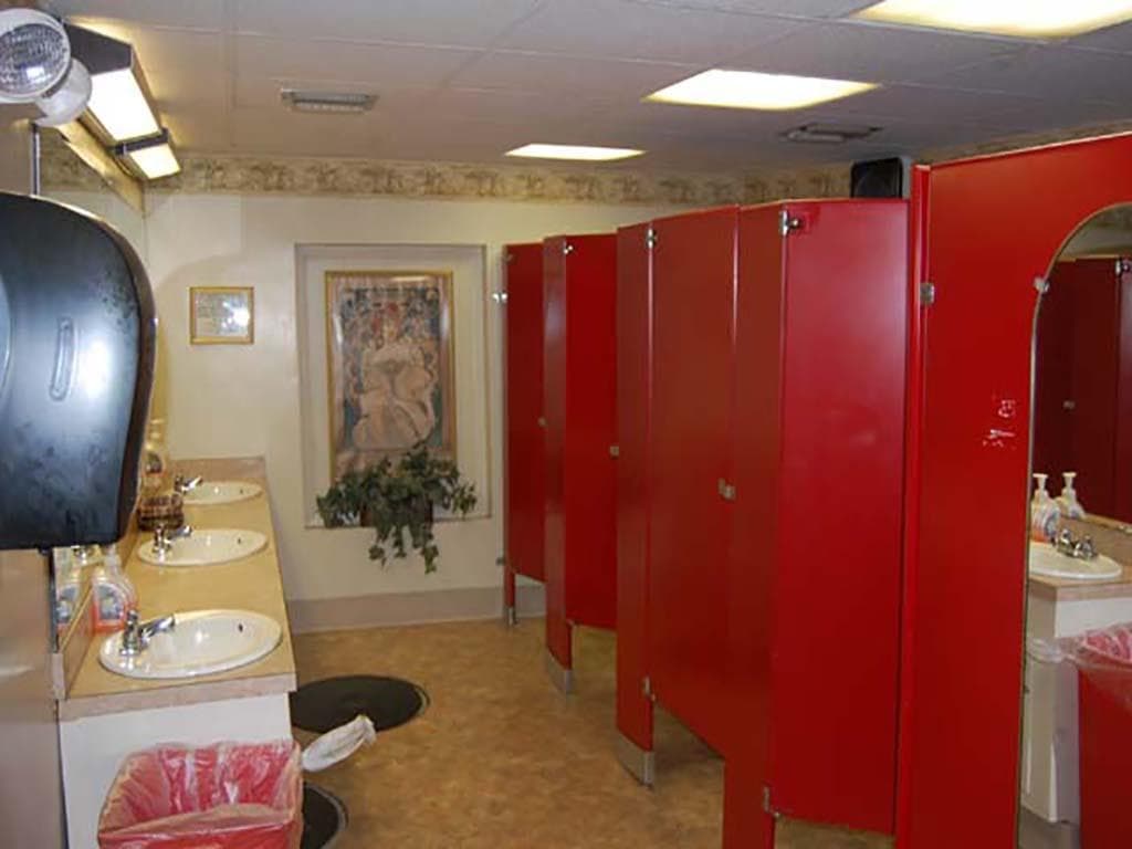 Red bathroom stalls and sinks on a 1985 Custom Serodino Dinner Boat.