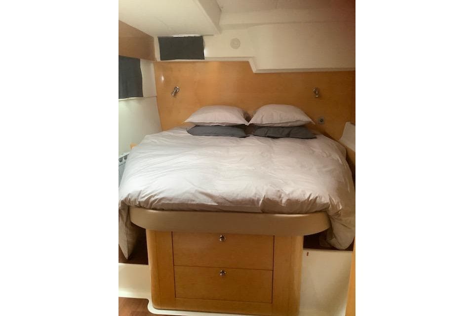 Cozy bedroom in 2008 Fountaine Pajot Salina 48 catamaran with wooden accents.