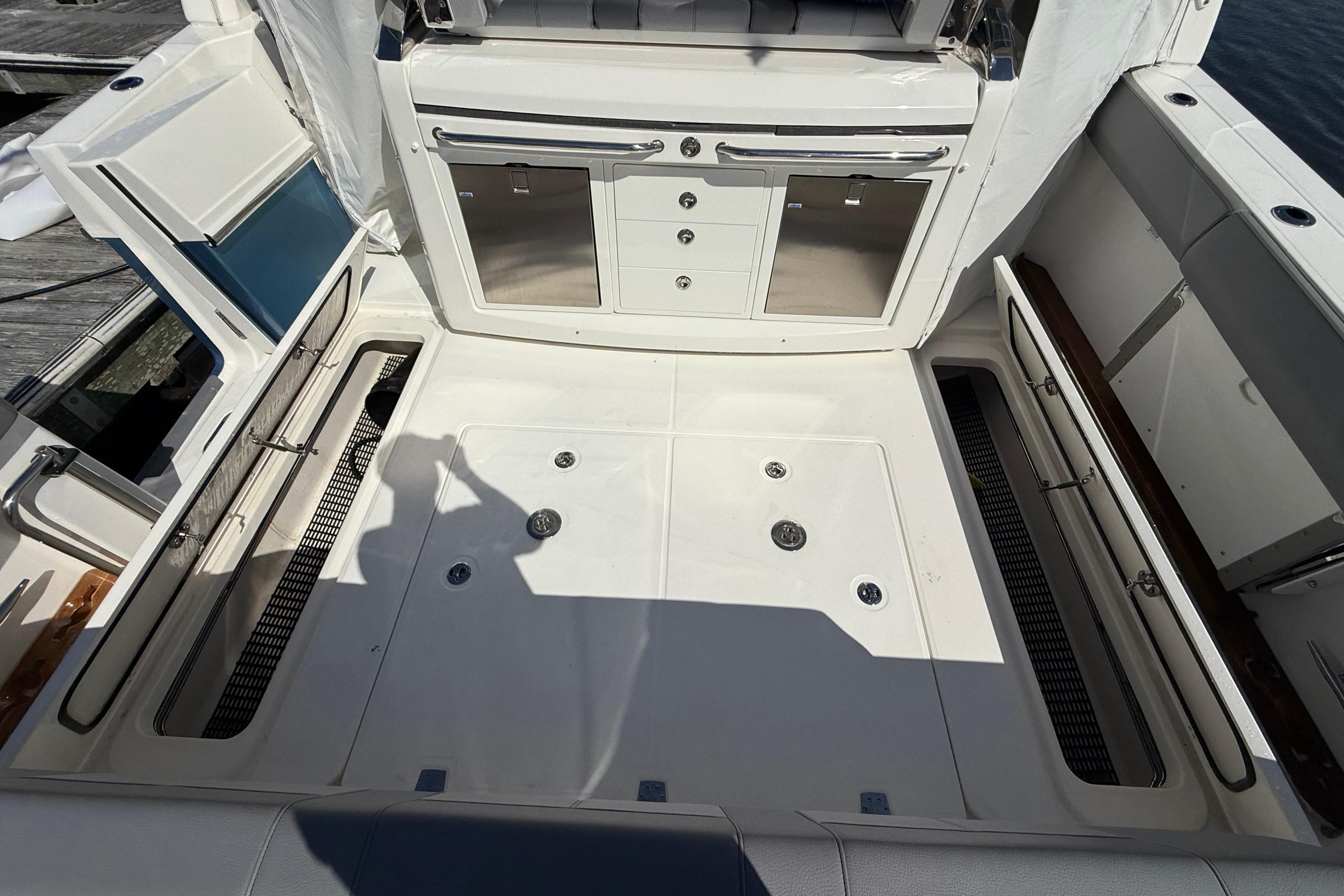 2024 Boston Whaler 420 Outrage deck with storage compartments and cabinetry.