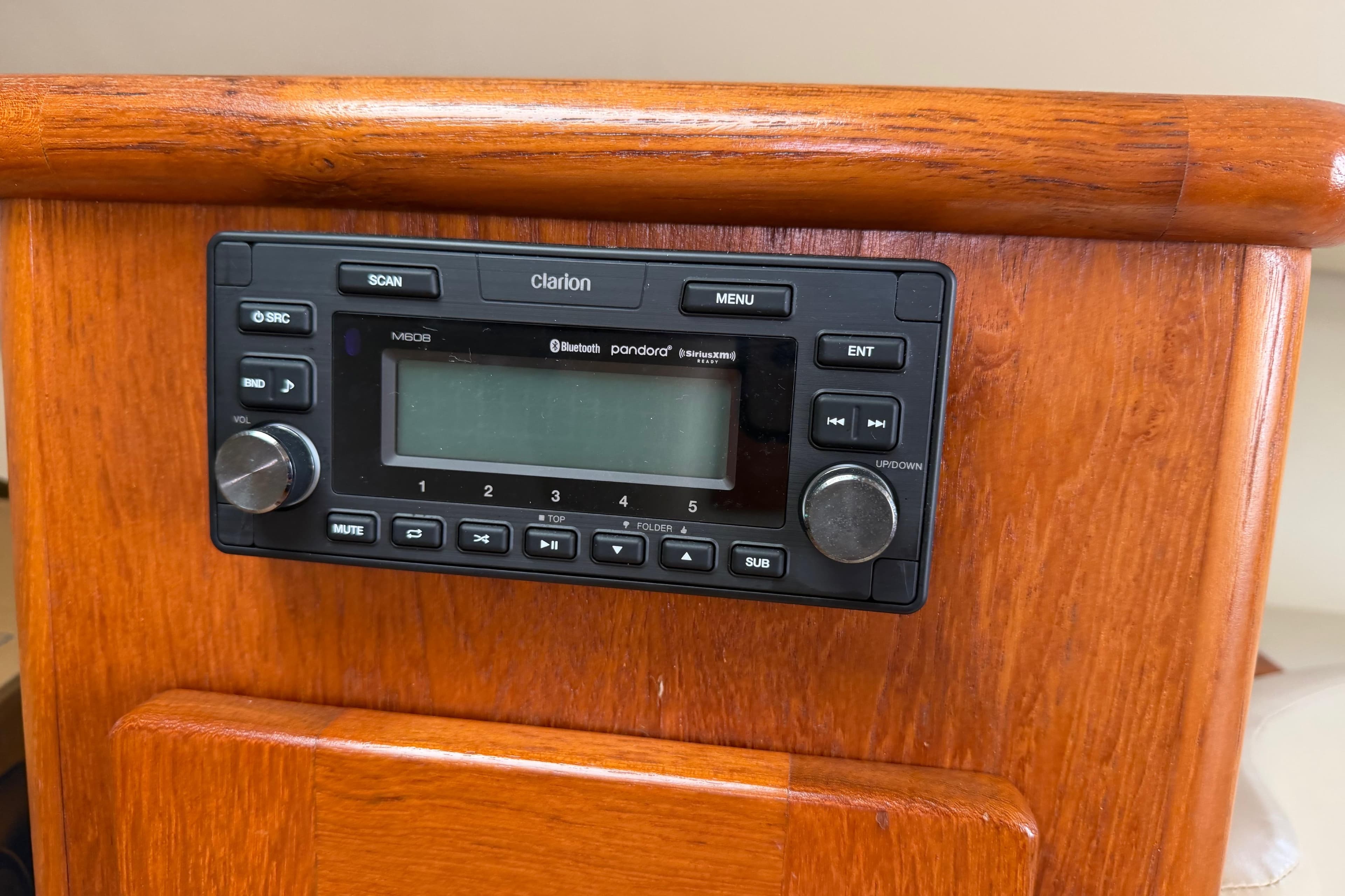 Clarion stereo system on 2008 Pursuit OS 335 Offshore boat's wooden dashboard.