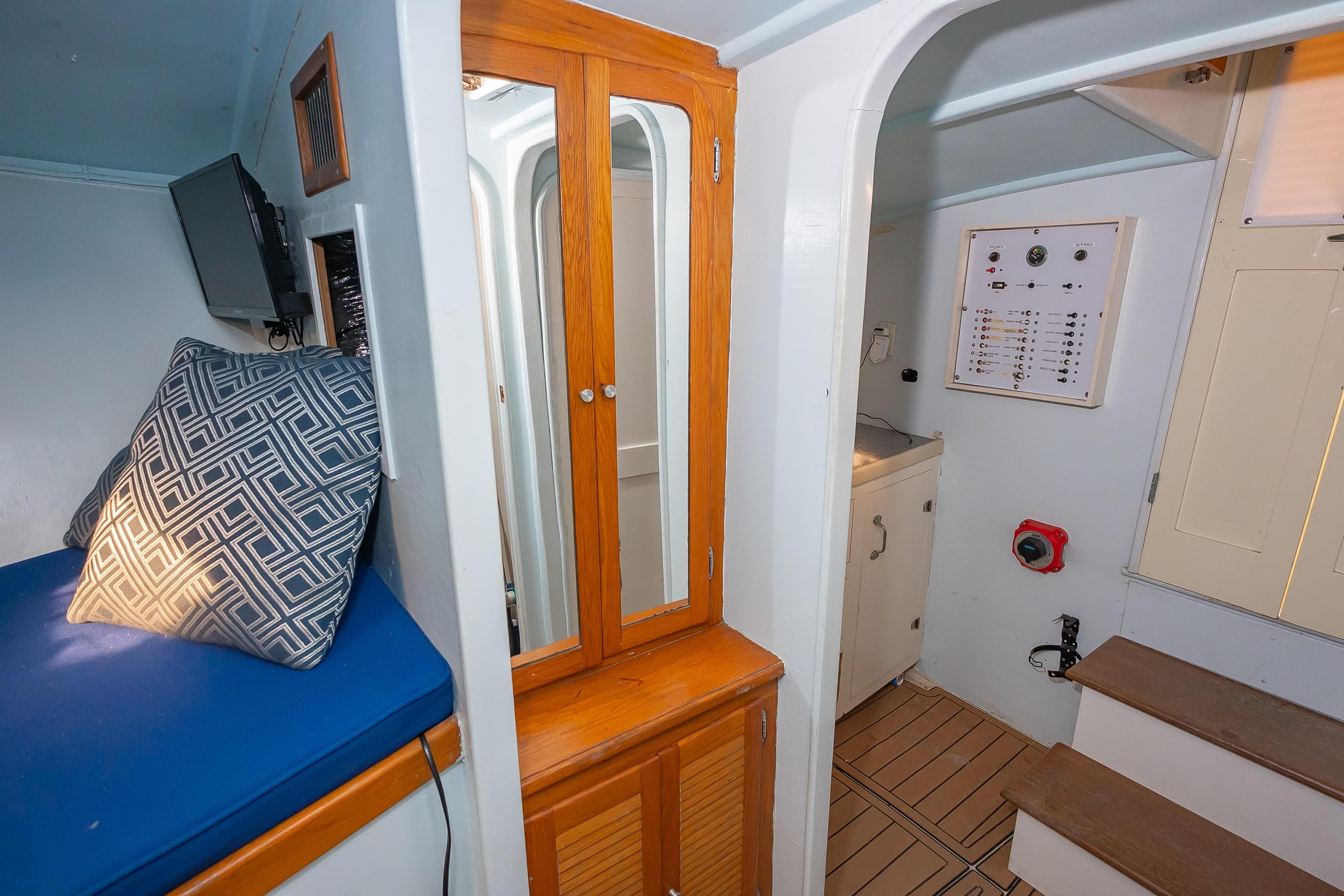 Interior of 1987 Custom Carolina Island Boatworks 34 Express, featuring seating, cabinetry, and control panel.