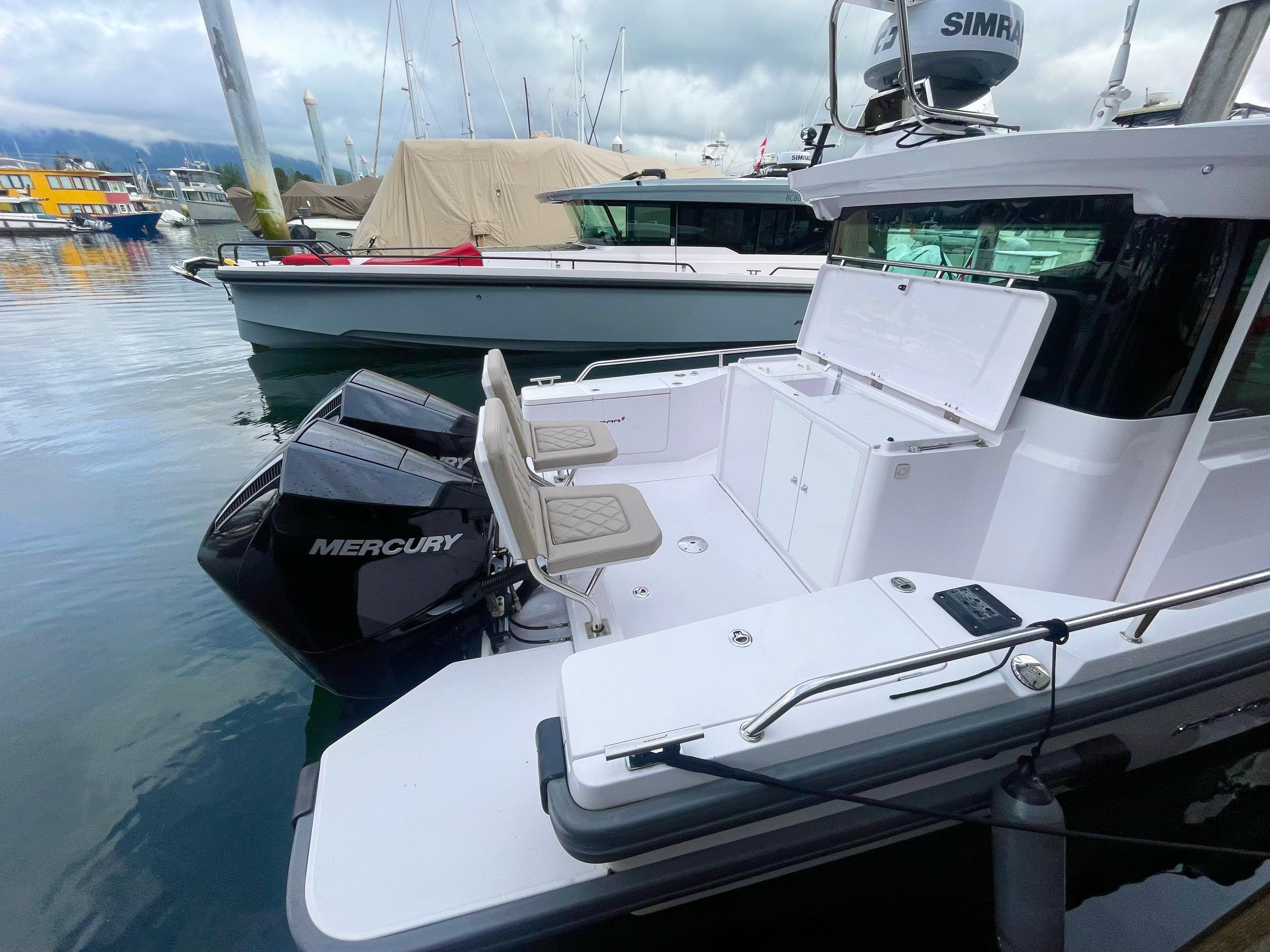 2022 Axopar 28 CABIN boat with Mercury engine docked at marina.