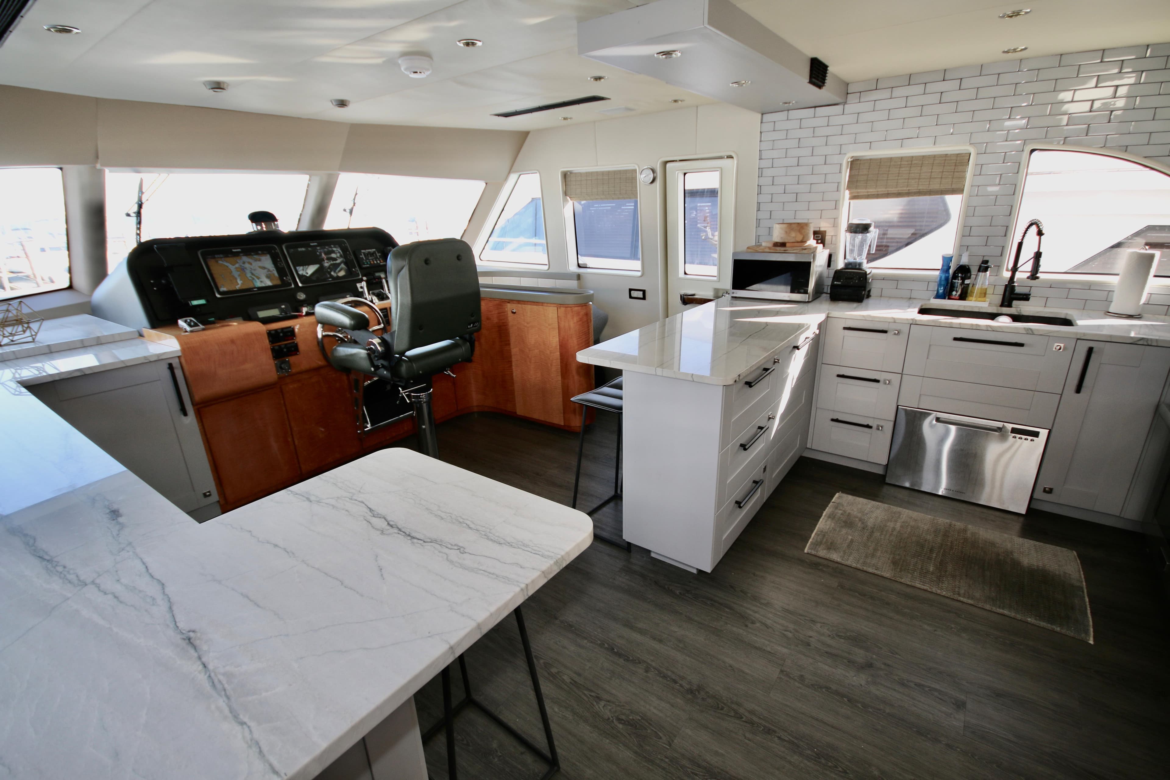 Luxurious 2002 Cheoy Lee 66 Pilothouse interior with modern kitchen and pilothouse area.