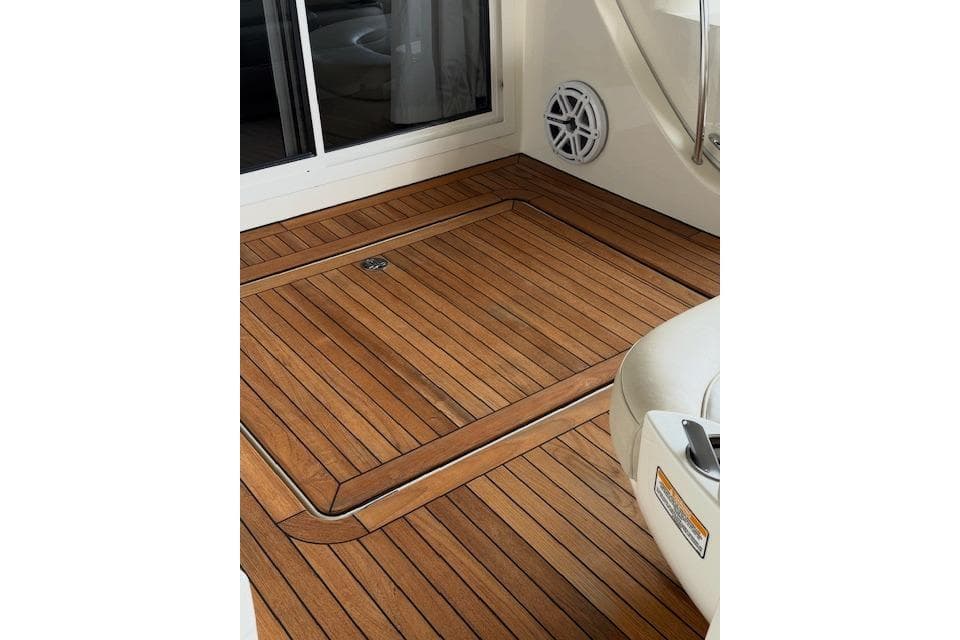 Teak deck of 2009 Meridian 391 Sedan yacht, featuring sleek wood finish and modern design.