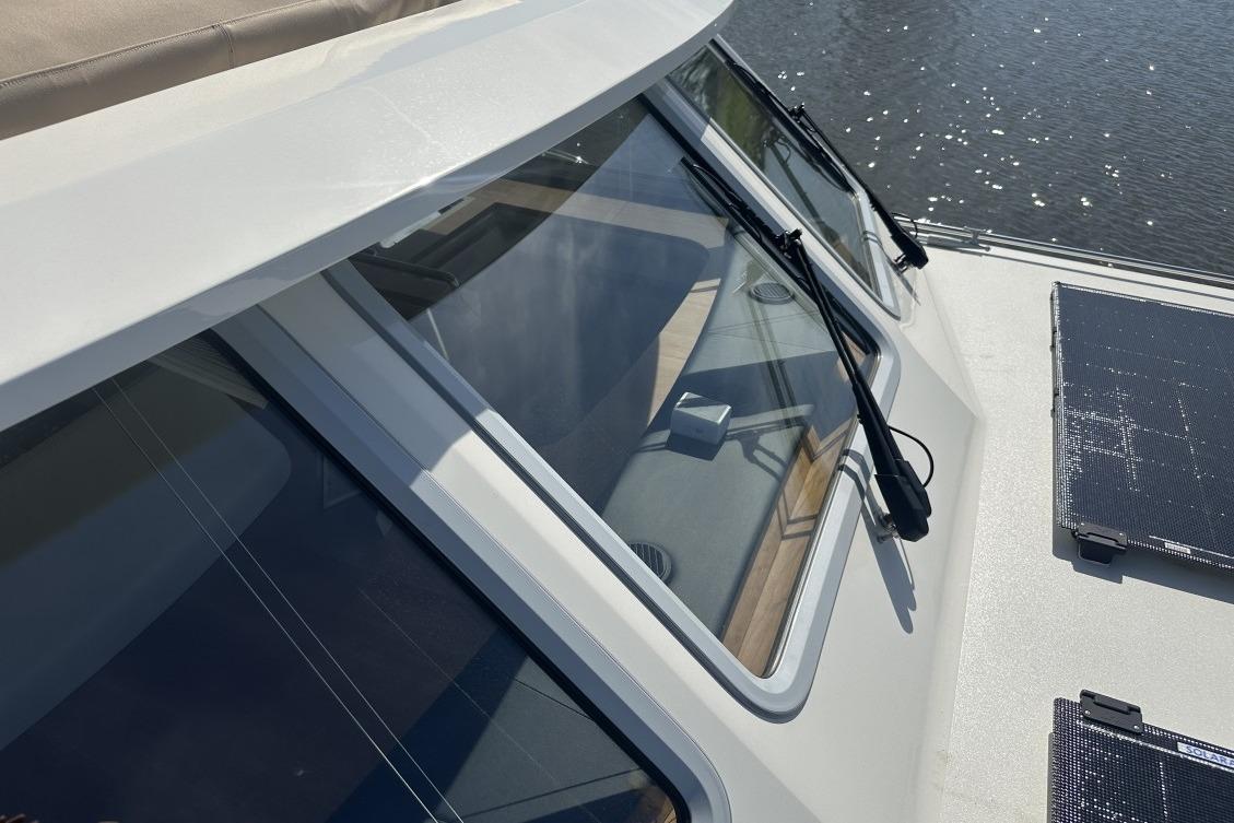2026 Linssen Grand Sturdy 550 Variotop yacht with sleek windows and solar panels.